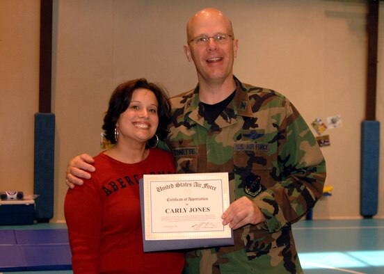 Col. Murrell "Tip" Stinnette, (right) 39th Air Base Wing commander, presents a Certificate of Appreciation to Carly Jones for her outstanding volunteer work at the Youth Center, Nov. 28. (U.S. Air Force photo by Airman Kelly L. LeGuillon) 