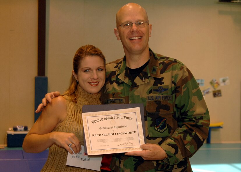 Col. Murrell "Tip" Stinnette, (right) 39th Air Base Wing commander, presents a Certificate of Appreciation to Rachael Hollingsworth for her outstanding volunteer work at the Youth Center, Nov. 28. (U.S. Air Force photo by Airman Kelly L. LeGuillon) 