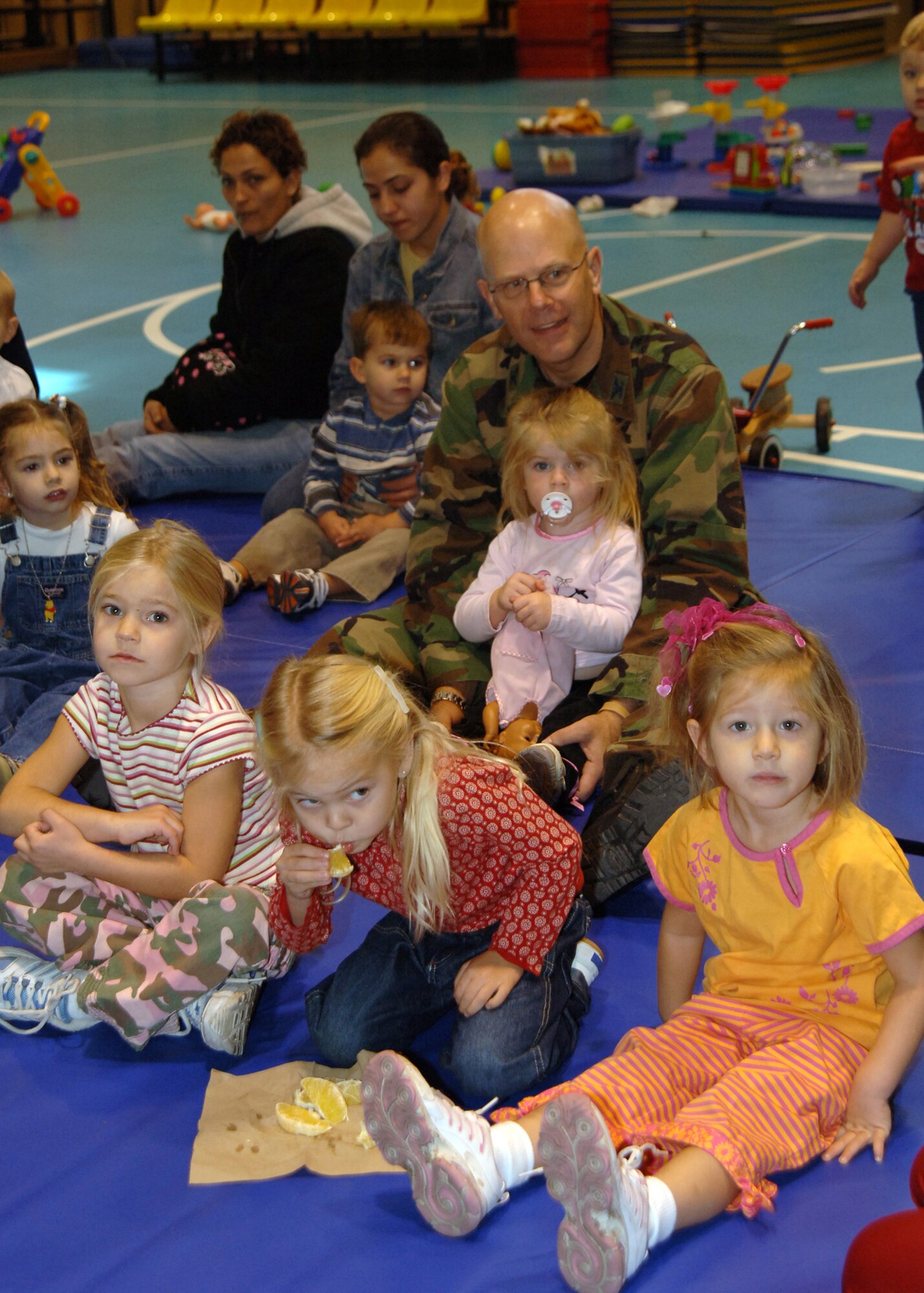 Col. Murrell "Tip" Stinnette, (right) 39th Air Base Wing commander, prepares to sing songs with children of the preschool playgroup at the base Yout.h Center, following a volunteer appreciation ceremony, Nov. 28. (U.S. Air Force photo by Airman Kelly L. LeGuillon) 