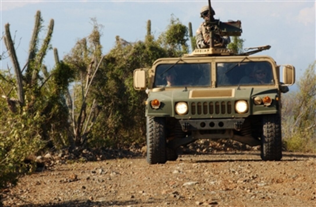Soldiers assigned to the U.S. Army's Echo Company, 629th Military Intelligence Battalion, patrol an area near the Joint Task Force Guantanamo detention center on Naval Base Guantanamo Bay, Cuba, on Nov. 17, 2006.  The company's main missions, as part of the task force, include perimeter security as well as acting as a quick reaction force should something happen inside the detention center. 