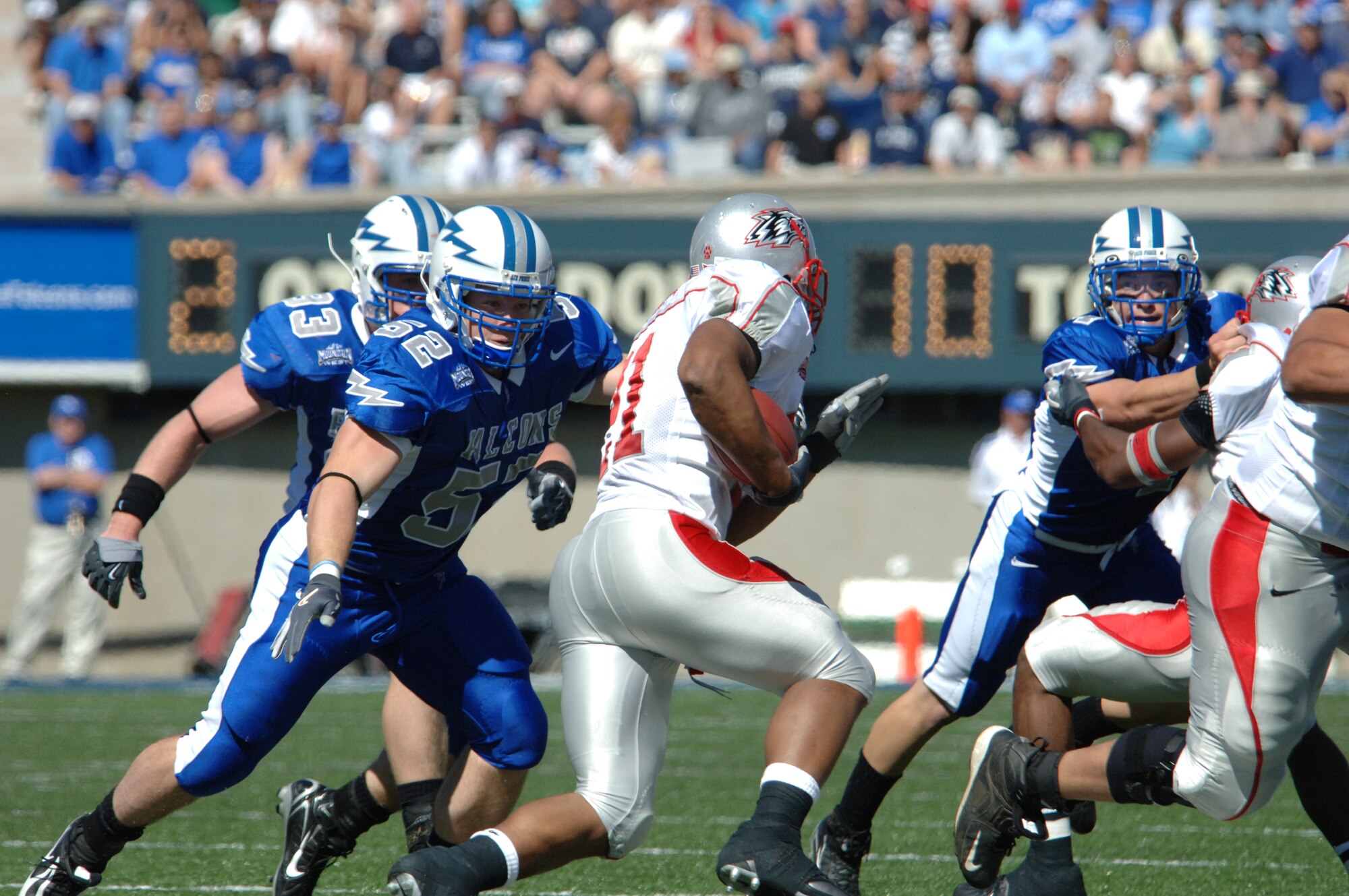 Falcons linebacker Austin Randle, #52, runs down New Mexico tailback Rodney Ferguson Sept. 30. The Falcons' defense held New Mexico to 41 yards rushing. Air Force went on to defeat the Lobos 24-7. (U.S. Air Force photo/John Van Winkle)