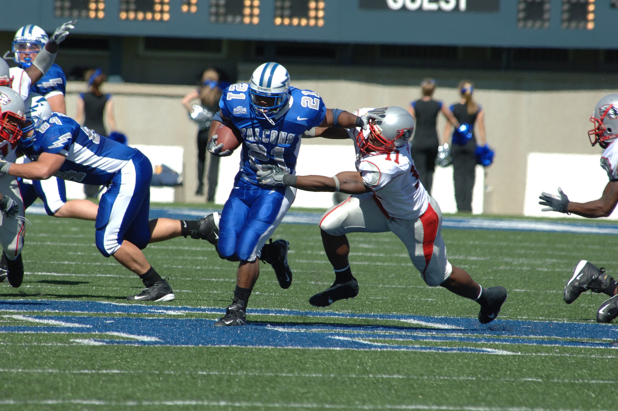 Air Force fullback Ryan Williams stiff-arms New Mexico defender Quincy Black as he runs for extra yardage up the middle in their Sept. 30 game. The Falcons fullback gained 94 yards and one touchdown on 22 carries, in their 24-7 victory over New Mexico. (U.S. Air Force photo/John Van Winkle)