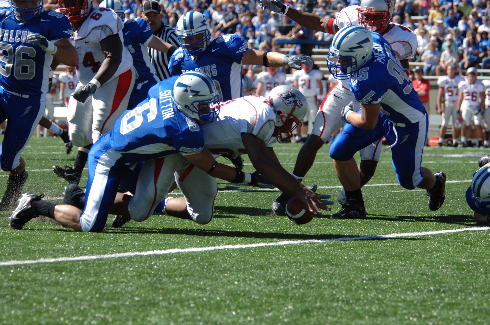 Falcons cornerback Chris Sutton grabs for a fumble by New Mexico tailback Rodney Ferguson on the second play of their game Sept. 30. Sutton recovered the fumble on the New Mexico 15-yard line. This set up Air Force's first score six plays later. Air Force went on to win 24-7 over New Mexico, improving its record to 2-1. (U.S. Air Force photo/John Van Winkle)