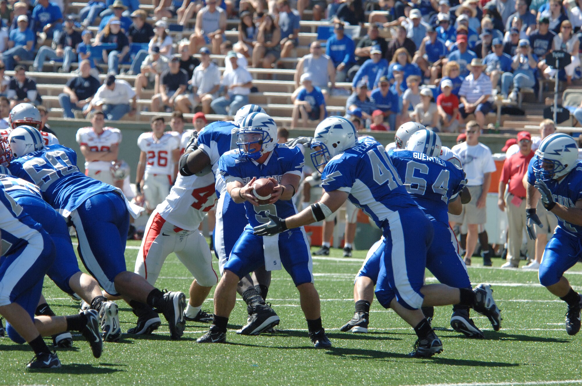 Air Force quarterback Shaun Carney hands off to fullback Scott Peeples. The fullback carried 11 times for 33 yards, as the Falcons' triple-option rushing offense netted 262 yards against New Mexico in Sept. 30's 24-7 victory. The Falcons improved their season record to 2-1 and stand at 2-0 in the Mountain West Conference.  Air Force's next opponent is Navy Oct. 7 at Falcon Stadium. (U.S. Air Force photo/John Van Winkle)