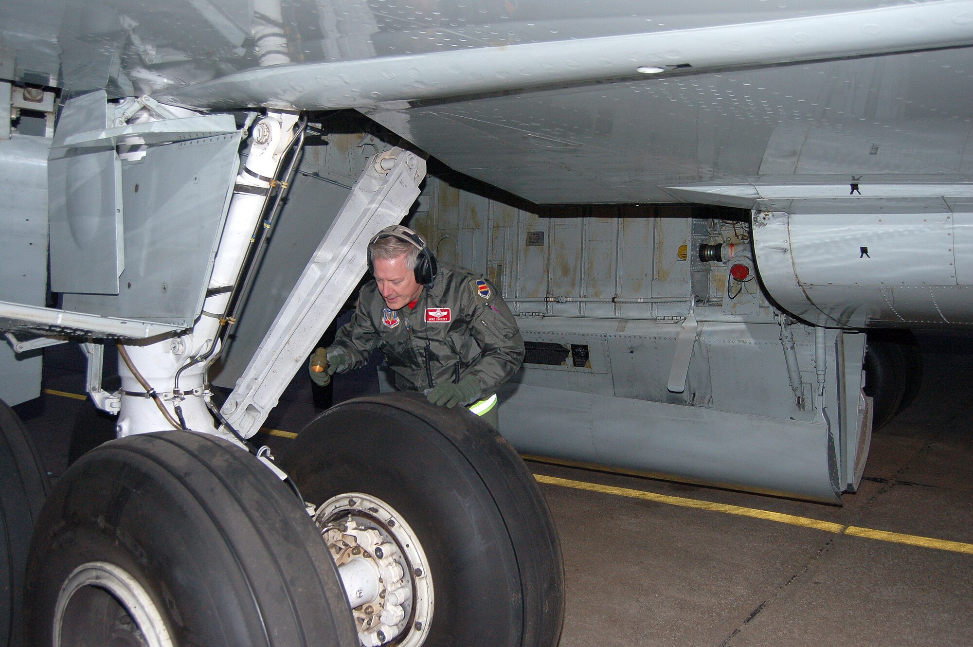 Lt. Col. Michael Swigert inspects the underside of an RC-135V/W Rivet Joint reconnaissance aircraft prior to a training mission at Lincoln Air Park in Lincoln, Neb., Sept. 29. He is an aircraft commander and instructor with the 343rd Reconnaissance Squadron at Offutt Air Force Base, Neb. Base aircraft and support units are temporarily operating from the air park ramp while the base's runway is under repair.  (U.S. Air Force photo/Staff Sgt. Shad Eidson)