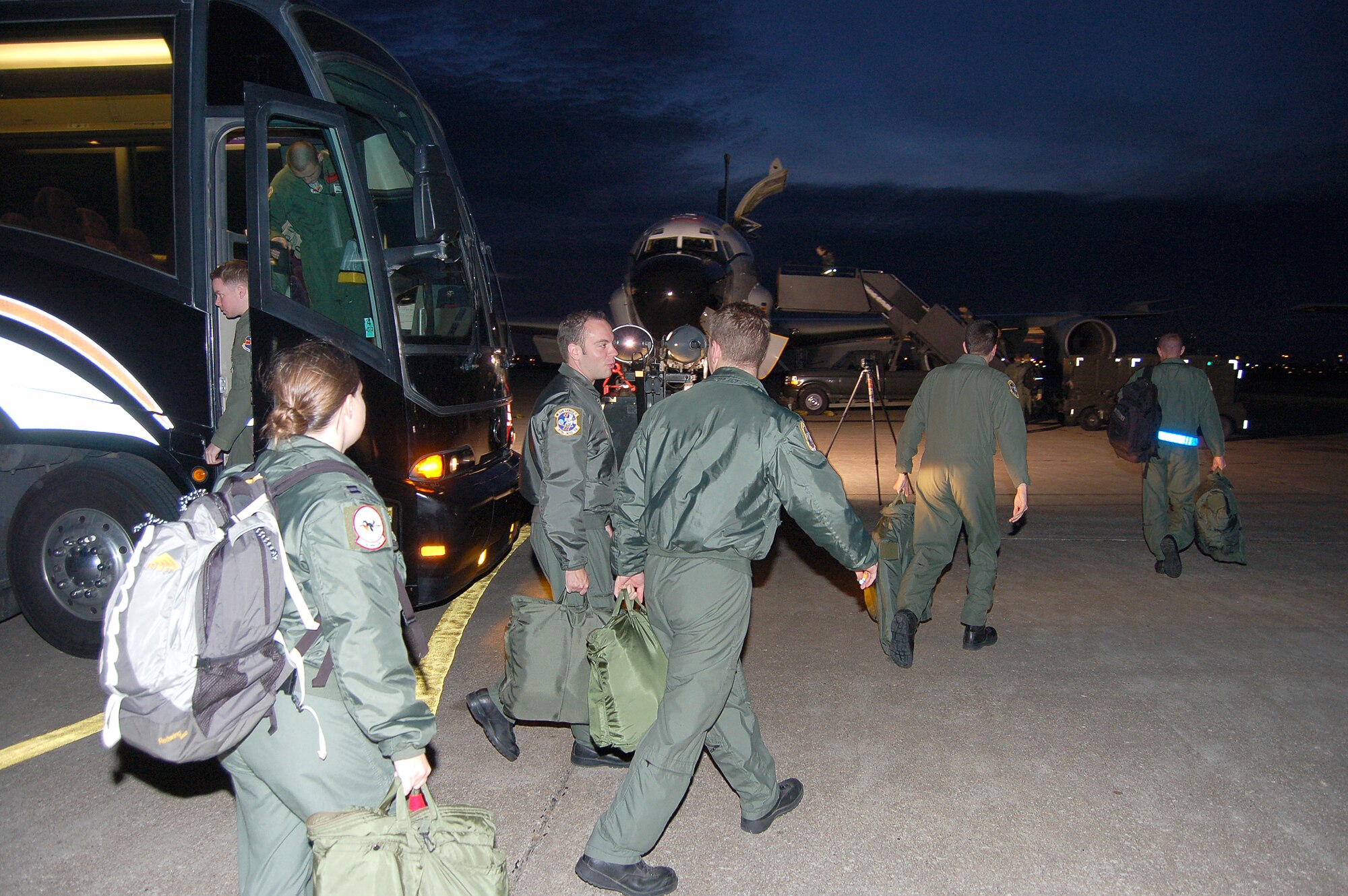 Aircrew members retrieve gear from their bus before boarding an RC-135V/W Rivet Joint reconnaissance aircraft for a training mission at Lincoln Air Park in Lincoln, Neb., Sept. 29. The 55th Wing at Offutt Air Force Base, Neb., temporarily moved base aircraft and support units to the air park while the base's runway is under repair. (U.S. Air Force photo/Staff Sgt. Shad Eidson)