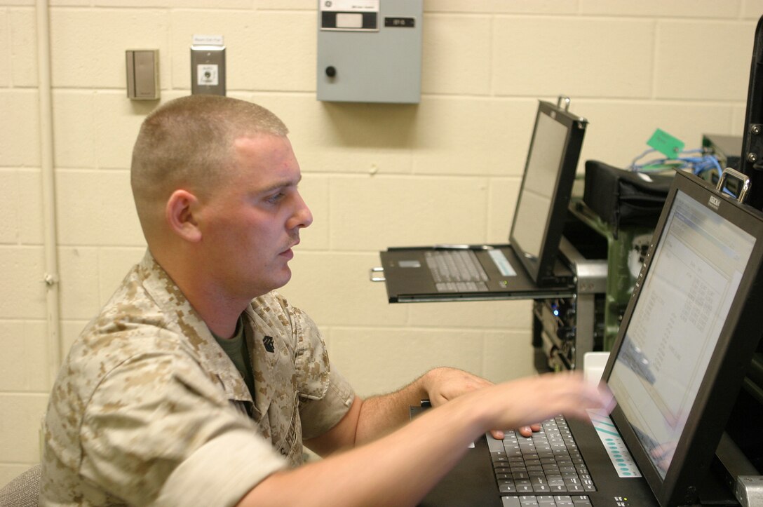 Sgt. Matthew J. Perry, 25, of Northville, NY, troubleshoots a virtual local area network for video teleconferencing here October 2. Perry is a data supervisor for Communications Platoon, 6th Marine Regiment, 2nd Marine Division, and is responsible for implementing data policies for the regiment. Perry is participating in the Mission Readiness Exercise along with units from 2nd Marine Air Wing, 2nd Marine Logistics Group and Army units based out of Fort Hood, Texas.