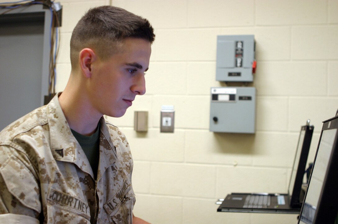 Lance Cpl. Robert P. Courtney, 2y, of Chugiak, Alaska, configures an an e-mail server here October 2. Courtney is a data Marine with Communications Platoon, 6th Marine Regiment, 2nd Marine Division, and is responsible for implementing data policies for the regiment. Courtney is participating in the Mission Readiness Exercise along with units from 2nd Marine Air Wing, 2nd Marine Logistics Group and Army units based out of Fort Hood, Texas.