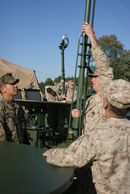 Marines from the 26th Marine Expeditionary Unit practice using the MEU's new MSWAN satellite communications system Oct. 2, 2006, at Ft. Pickett, Va.  The MSWAN system will allow the MEU to deploy its elements to a distance of 10,000 miles apart and still maintain data and voice connectivity.(Official USMC photo by Lance Cpl. Aaron J. Rock)  (Released)