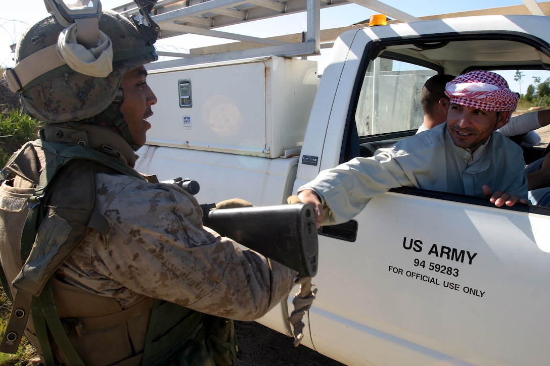 Private First Class Brandon King, a rifleman with Golf Company, Battalion Landing Team 2nd Bn., 2nd Marine Regiment, 26th Marine Expeditionary Unit, greets an  actor portraying an Arab civilian during scenario training Oct. 2, 2006, at Fort Pickett, Va., during the Marine Expeditionary Unit Exercise.  (Official USMC photo by Cpl. Jeremy T. Ross) (Released)