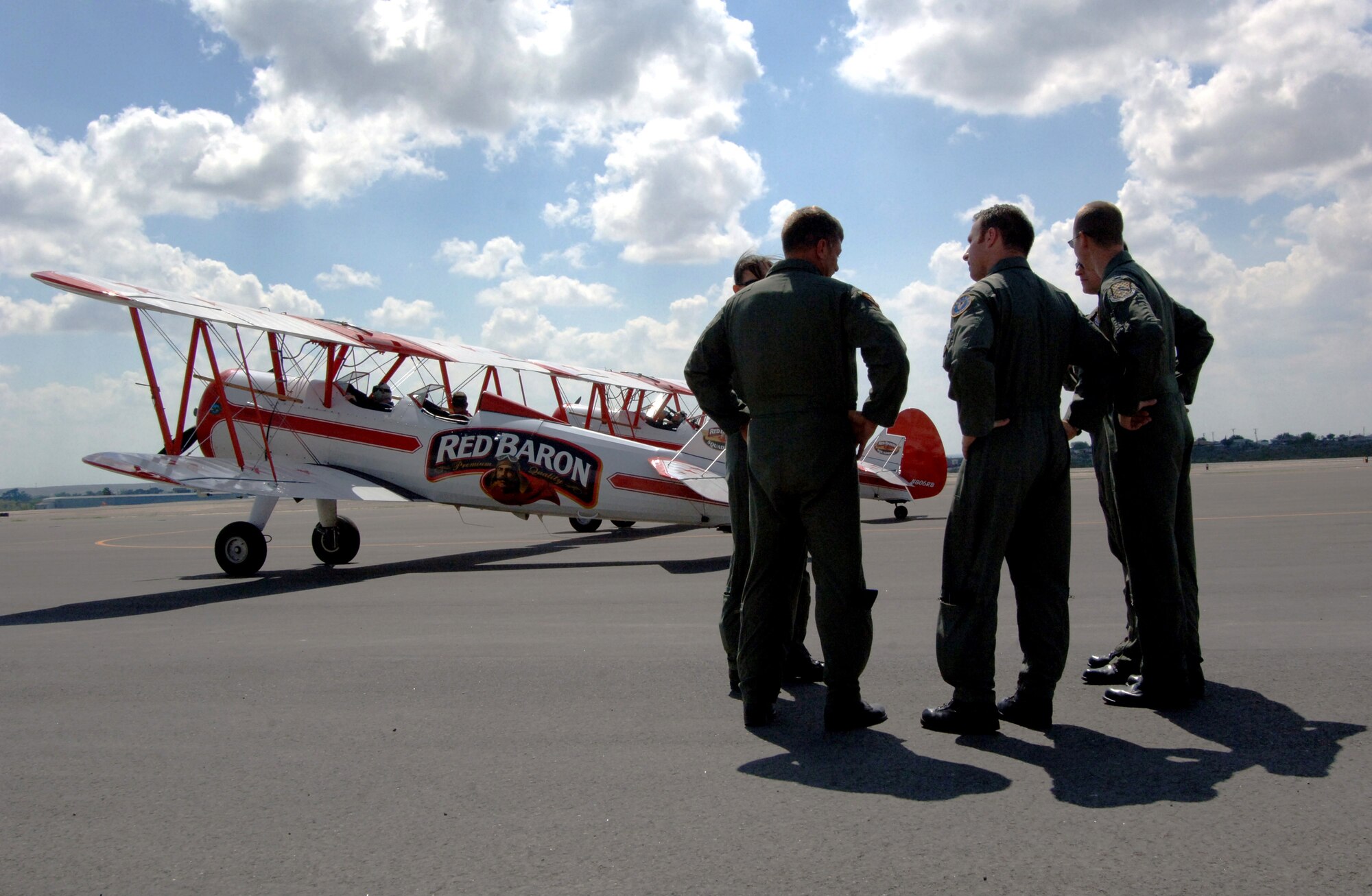 Airmen from Laughlin Air Force Base wait for their incentive flight from the Red Baron Pizza Squadron at Del Rio, Texas, on Oct. 1. The Red Barons are vintage "Stearman" biplanes able to perform acrobatic stunts and is the longest-running, non-military air show act in history. (U.S. Air Force photo/Tech. Sgt. Larry A. Simmons)