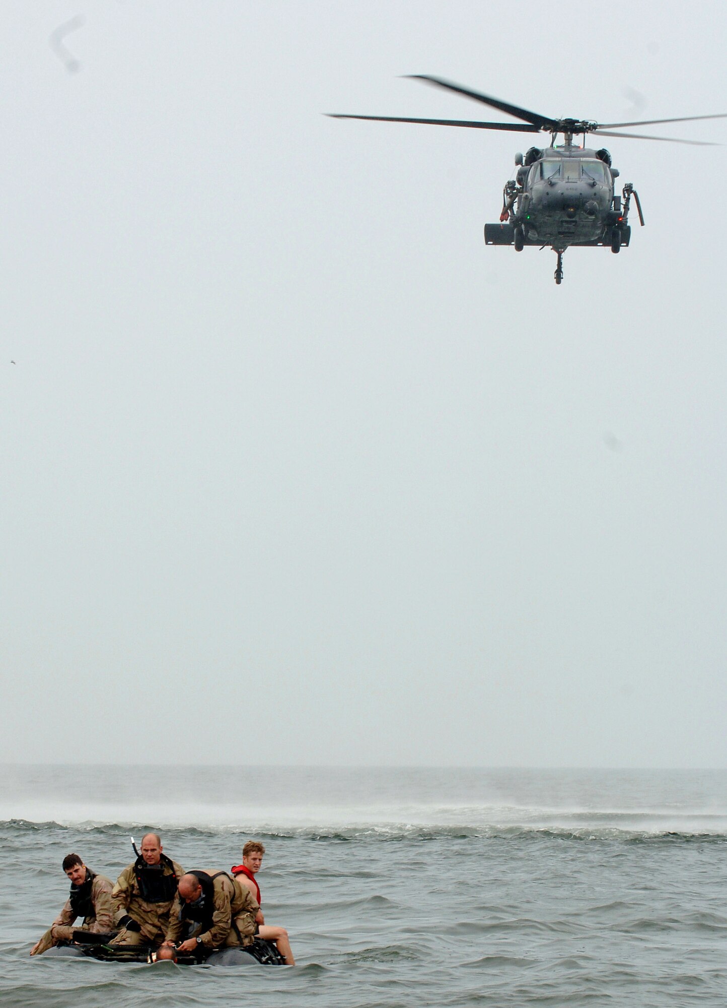 Pararescuemen from the 347th Rescue Group at Moody Air Force Base, Ga., prepare to extract "survivors" during "Kangaroo Duck" training recently in the Gulf of Mexico off the coast of Apalachicola, Fla.  The K-Duck is an inflatable raft that is strapped to the underbelly of a rescue helicopter so it can be easily dropped to better assist with water-rescue scenarios like those experienced during Hurricane Katrina.  (U.S. Air Force photo/Airman 1st Class Schelli Jones)