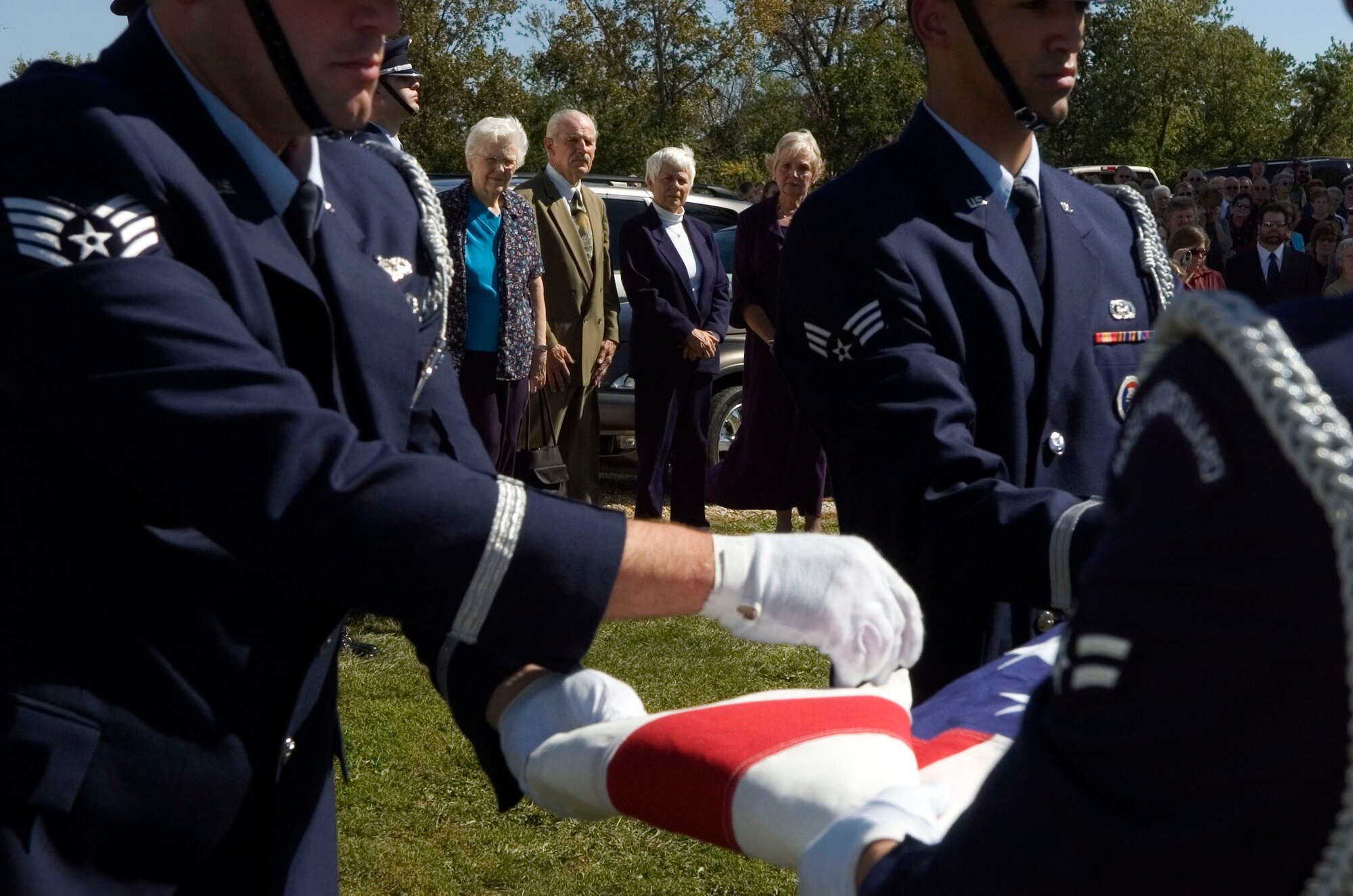 Honor Guard members from Scott Air Force Base, Ill., conduct a flag ceremony Oct. 1 during a memorial service for 1st Lt. Bruce Sweney, an Air Force pilot shot down over North Korea in 1951. Lieutenant Sweney's brother and three sisters (background) attended the service held in a rural church near Avon, Ill., where he grew up before entering the Air Force. He is one of 389 still listed as missing in action from the Korean War. (U.S. Air Force photo/Master Sgt. Jack Braden) 