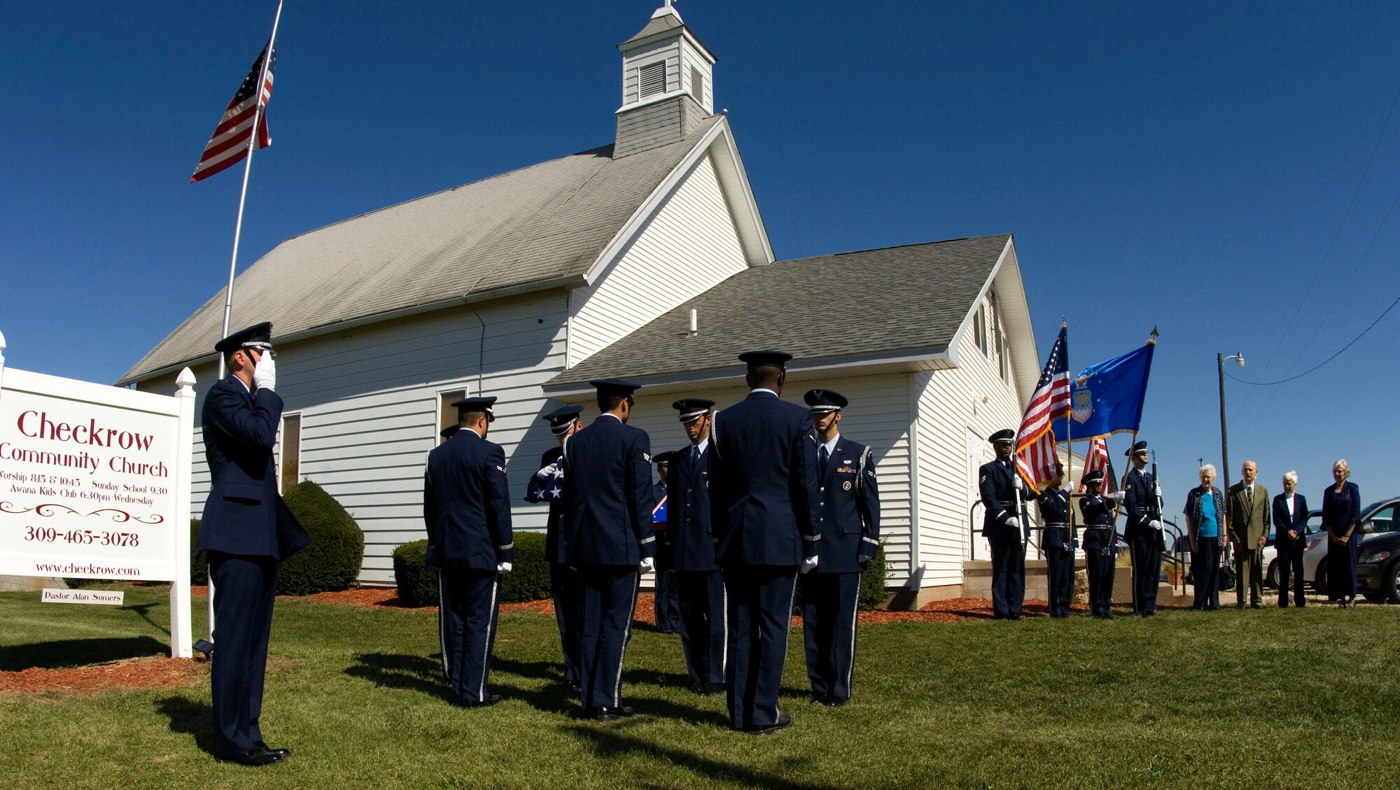 Honor Guard members from Scott Air Force Base, Ill., conduct a flag ceremony Oct. 1 during services honoring 1st Lt. Bruce Sweney, an Air Force pilot who was shot down over North Korea in 1951. Lieutenant Sweney's brother and three sisters (far right) attended the service at a rural church near Avon, Ill., where the reconnaissance pilot grew up before entering the Air Force. He is one of 389 still listed as missing in action from the Korean War. (U.S. Air Force photo/Master Sgt Jack Braden)