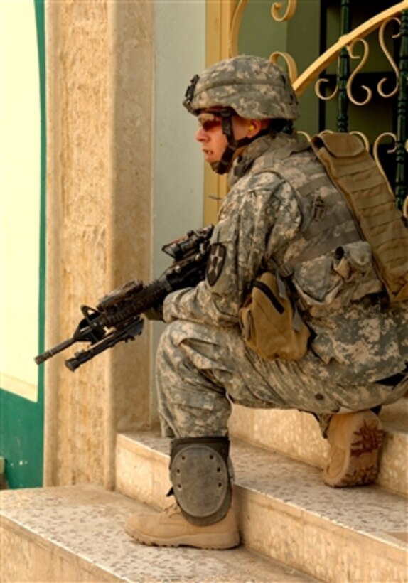U.S. Army Spc. Raymond Henderson provides security during a patrol in Mosul, Iraq, on Sept. 24, 2006.  Henderson is assigned to 2nd Battalion, 3rd Infantry Regiment, 3rd Stryker Brigade, 2nd Infantry Division.  