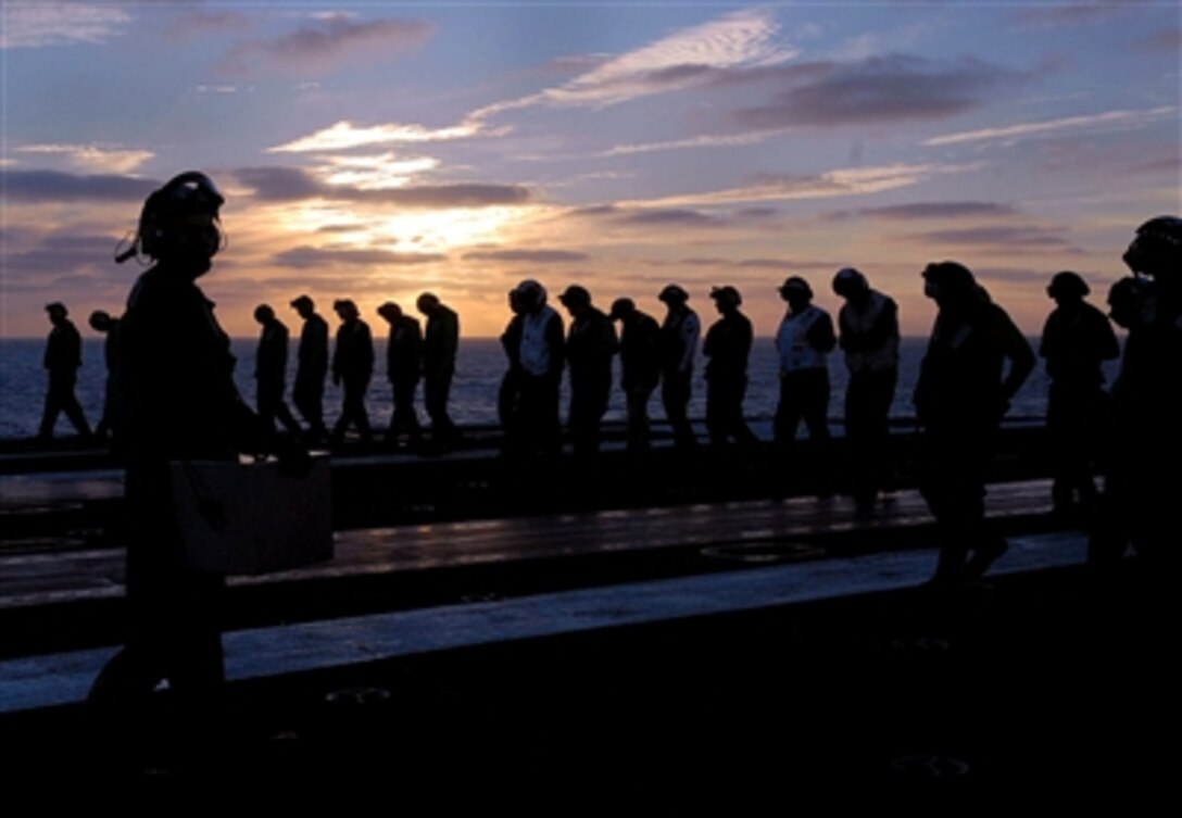 Sailors conduct a foreign object damage walk-down prior to flight operations aboard the nuclear-powered aircraft carrier USS John C. Stennis in the Pacific Ocean, Sept. 27, 2006. 