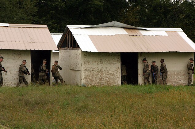 CAMP DAWSON, WEST VIRGINA ? (October 6, 2006)? Marines with Marine Corps Barracks 8th and I conduct simulated house raids during part of FMTU?s ORE. Teams-4 and-6 completed their final exercise with the help of the Marines and contracted linguists as role players for the event. (Official U.S. Marine Corps Photo by Cpl. Ken Melton)