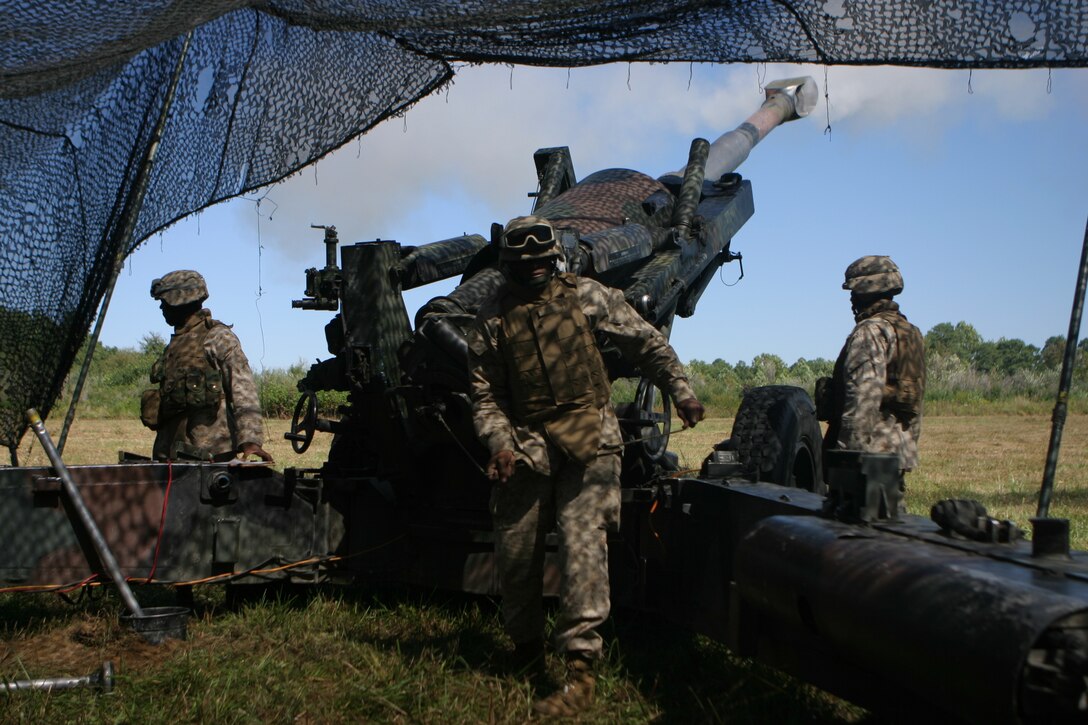 Lance Corporal Shane G. Johnson, a cannoneer with Battery K, Battalion Landing Team, 2nd Bn., 2nd Marine Regiment, 26th Marine Expeditionary Unit, pulls the lanyard to commence an artillery fire-mission during training Oct. 3, 2006, at Fort Pickett, Va.  The Marines are training for their upcoming deployment with the 26th MEU in early 2007.
