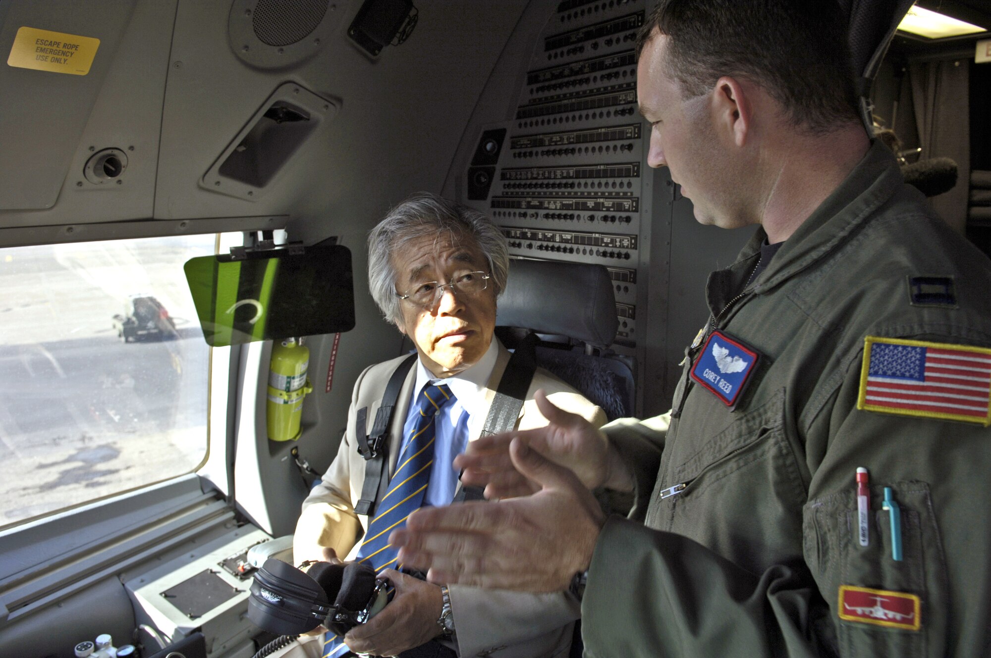 Capt. Corey Reed highlights the capabilities of the C-17 Globemaster III to Yoshiki Hidaka Sept. 27 at Hickam Air Force Base, Hawaii. Captain Reed is a pilot with 535th Airlift Squadron. Mr. Hidaka is the executive producer for "Yoshiki Hidaka, The Washington Report," an 80-minute documentary news program that broadcasts monthly for TV Tokyo Network in Japan. (U.S. Air Force photo/Tech. Sgt. Shane A. Cuomo) 
