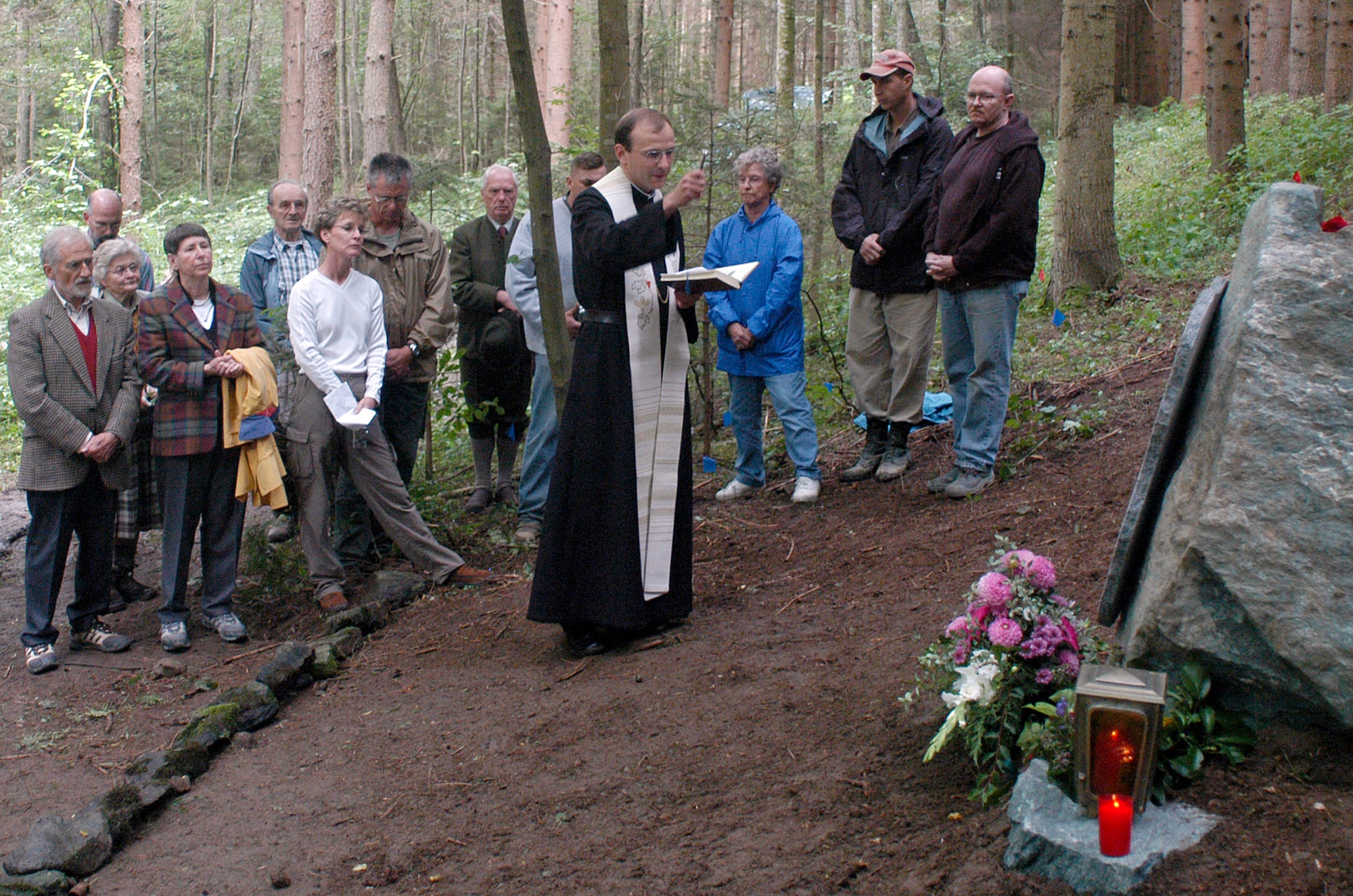A priest from nearby Vostenhof, Austria, presides over an Aug. 27 memorial service for the members of a B-17 bomber that crashed in the area May 10, 1944. The service was attended by family, friends and members of the Joint POW/MIA Accounting Command. An 18-member JPAC team, including a forensic anthropologist, explosive ordnance disposal technician and field medic, from Hickam Air Force Base, Hawaii, returned Oct. 1 after 45 days in Austria attempting to recover the remains of 1st Lt. Stanley Dwyer and gunner Sgt. John Boros who were lost in the crash. The mission of JPAC is to achieve the fullest possible accounting of all Americans missing as a result of the nation's past conflicts. (U.S. Air Force photo/Staff Sgt. Derrick C. Goode)