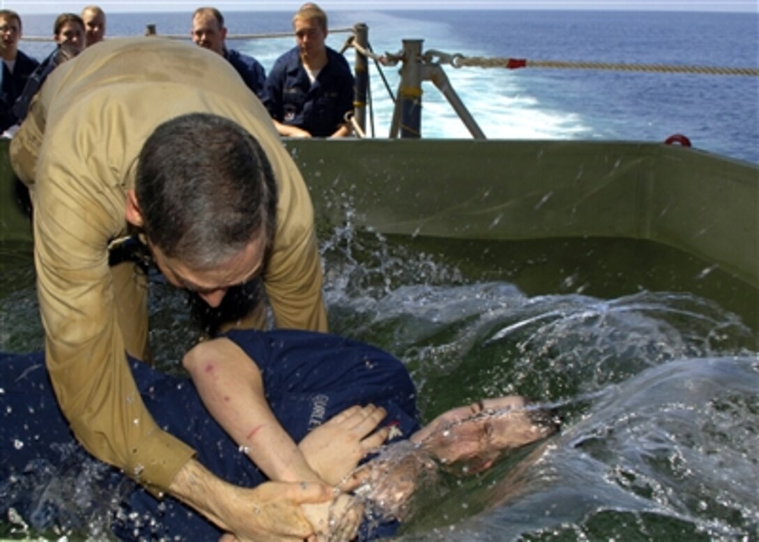 U.S. Navy Lt. David L. Masterson, chaplain Carrier Air Wing 1, baptizes Petty Officer 3rd Class Christopher Gurley aboard the USS Enterprise in the Arabian Sea, Oct. 1, 2006.  