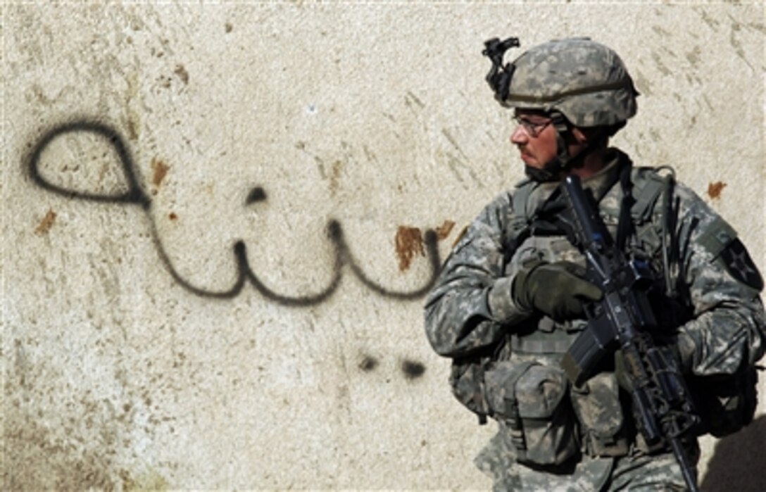 A U.S. Army soldier from 3rd Platoon, Alpha Company, 1st Battalion, 23rd Infantry Division provides security during a cordon and search mission in Baghdad, Iraq, Oct. 1, 2006. 