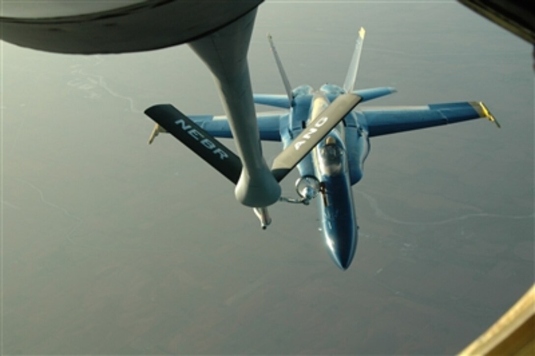 A U.S. Navy Blue Angels F/A-18 Hornet aircraft is refueled by a Nebraska Air National Guard KC-135R Stratotanker aircraft over Nebraska on Sept. 24, 2006.  The Navy Blue Angels are en route to Lincoln, Neb., to participate in the Guardians of Freedom Air Show.  