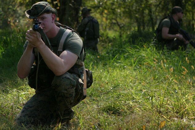 CAMP DAWSON, WEST VIRGINA ? (October 6, 2006)? Marines with Marine Corps Barracks 8th and I hold their position and sight in during a patrolling package part of FMTU?s ORE. Teams-4 and-6 completed their final exercise with the help of the Marines and contracted linguists as role players for the event. (Official U.S. Marine Corps Photo by Cpl. Ken Melton)