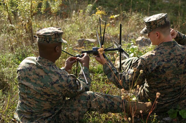 CAMP DAWSON, WEST VIRGINA ? (October 6, 2006)? Marines with Team-6 fix their satellite systems before starting classes here as part of FMTU?s ORE. Teams-4 and-6 completed their final exercise with the help of the Marines and contracted linguists as role players for the event. (Official U.S. Marine Corps Photo by Cpl. Ken Melton)