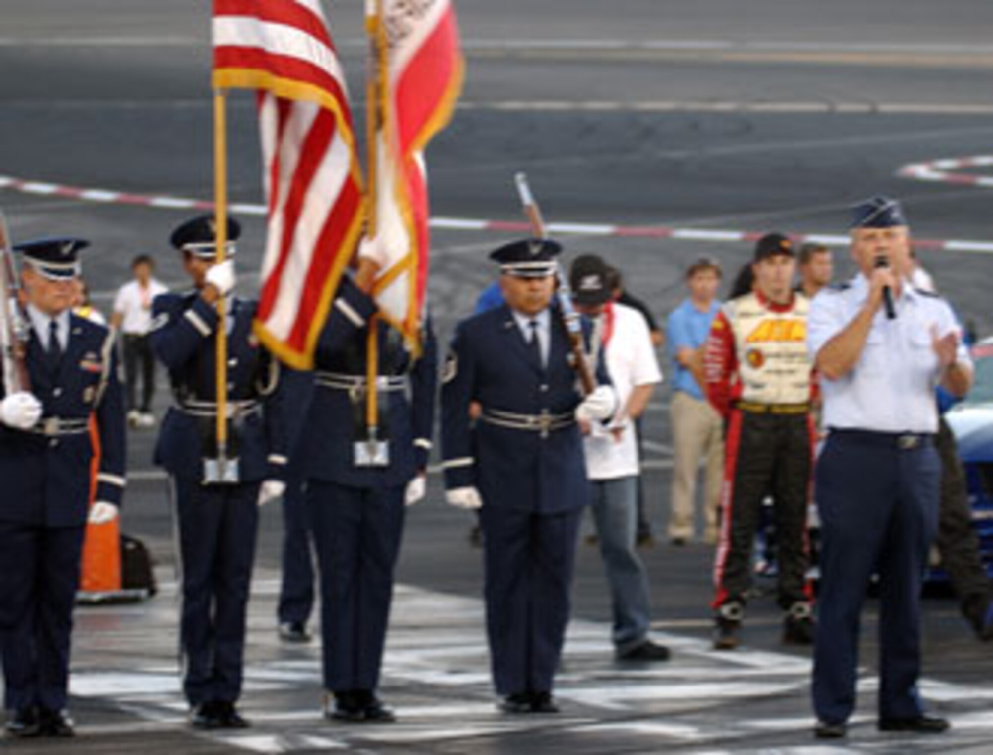 Brig. Gen. James L. Melin, commander, 452nd Air Mobility Wing, March Air Reserve Base, welcomes the crowd during the opening ceremonies at a drifting event at the Irwindale Speedway which was co-sponsored by the Air Force Reserve Command.  The members of the Blue eagles Total Force Honor Guard prepare to present the colors.  The event featured some of the best professional drifters in D1 taking on some of NASCAR’s brightest stars, including Kasey Kahne, Matt Kenseth, Bill Elliott, Greg Biffle, Robby Gordon and Casey Mears, in a drifting exhibition.  (U.S. Air Force photo by Mr. Erickson Barnes, 452 AMW/PA)