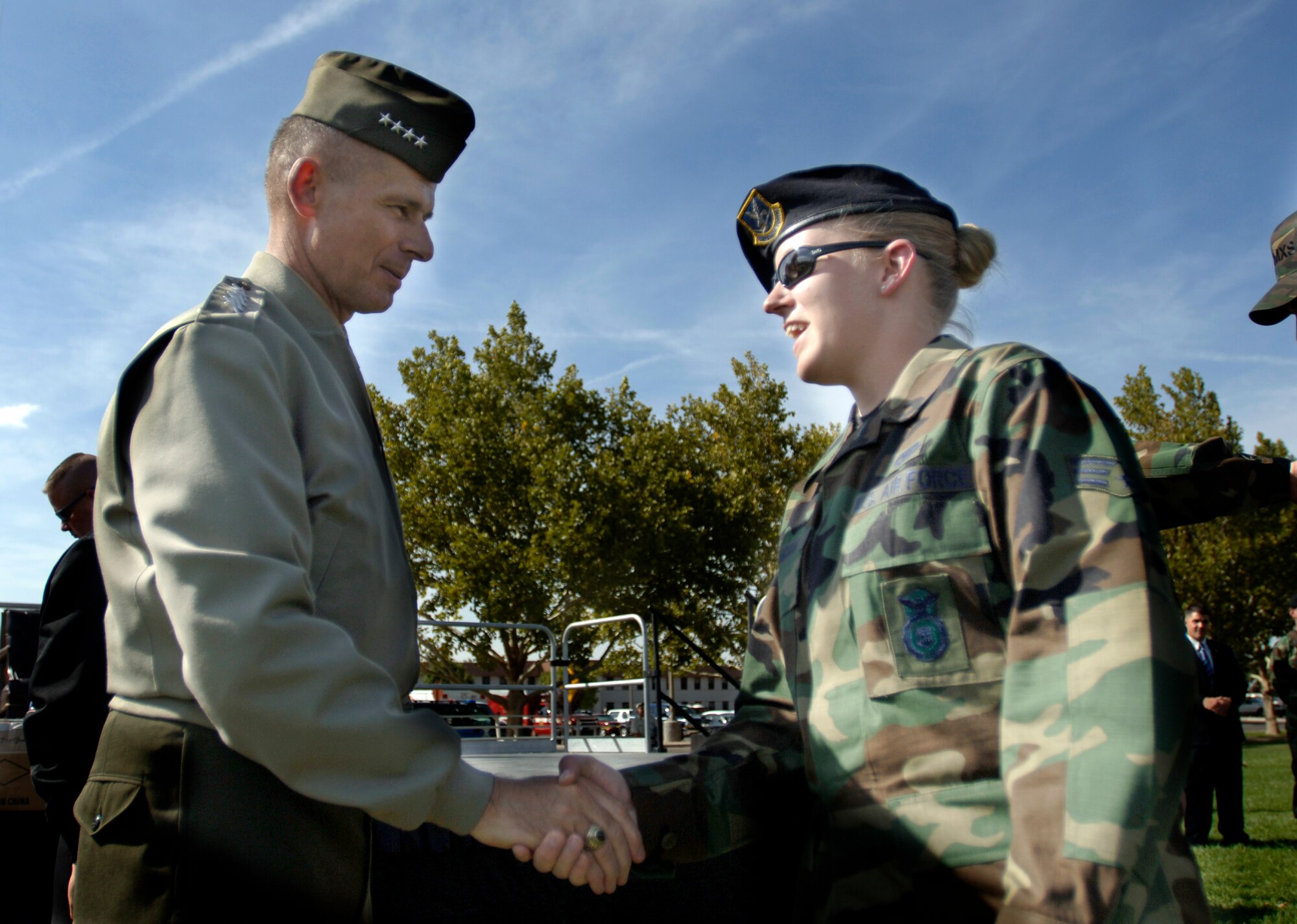 General Peter Pace gives his coveted coin to Senior Airman Heather Flanagan after his town meeting on Hardin Field in Kirtland AFB New Mexico, Oct. 4, 2006.  General Pace is the Chairman of the Joint Chiefs of Staff.  Senior Airman Flanagan is a Security Specialist with the 377 Security Force Squadron. (U.S. Air Force photo/Tech Sgt. Cecilio M. Ricardo Jr.)  