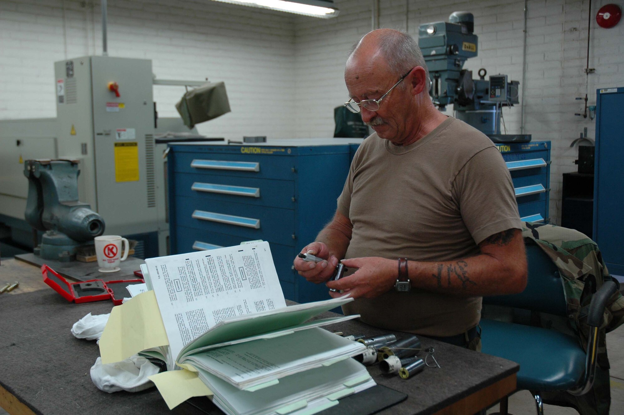 Tech. Sgt. James Donovan, 944th Maintenance Squadron aircraft metal technician, measures pins to ensure they meet the technical order tolerances while repairing nose landing gear. (U.S. Air Force photo/Staff Sgt. Susan Stout)