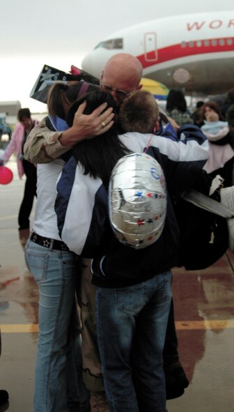 Tech. Sgt. Walter Anderson, with the 388th Equipment Maintenance Squadron, embraces his family after finding them in the crowd. (U.S. Air Force photo by Airman 1st Class Stefanie Torres)
