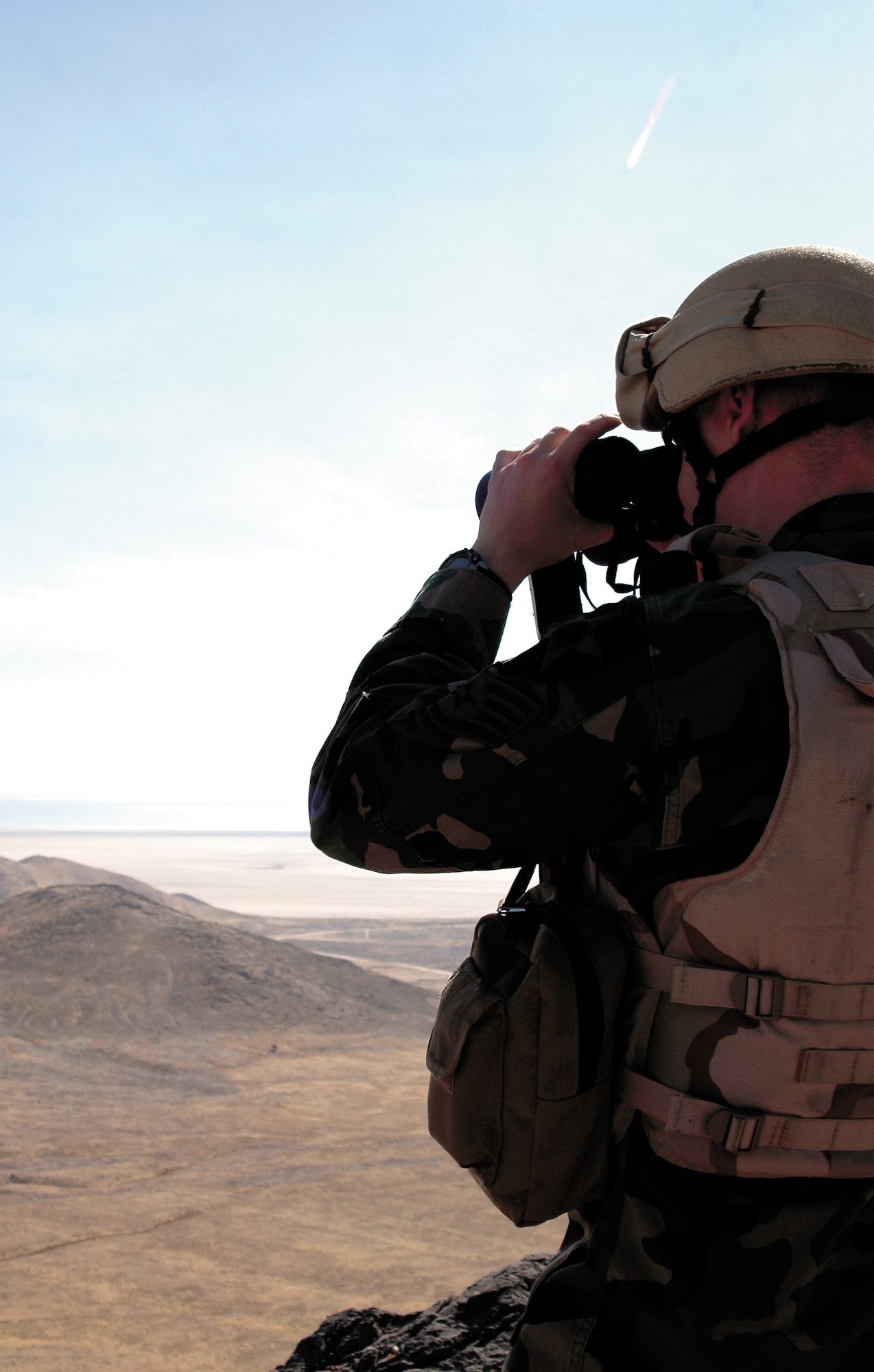 Staff Sgt. Adam Smith, a Joint Tactical Air Control Party member, looks through his binoculars for enemy positions to call in an air strike during training. (U.S. Air Force photo by Airman 1st Class Stefanie Torres)
