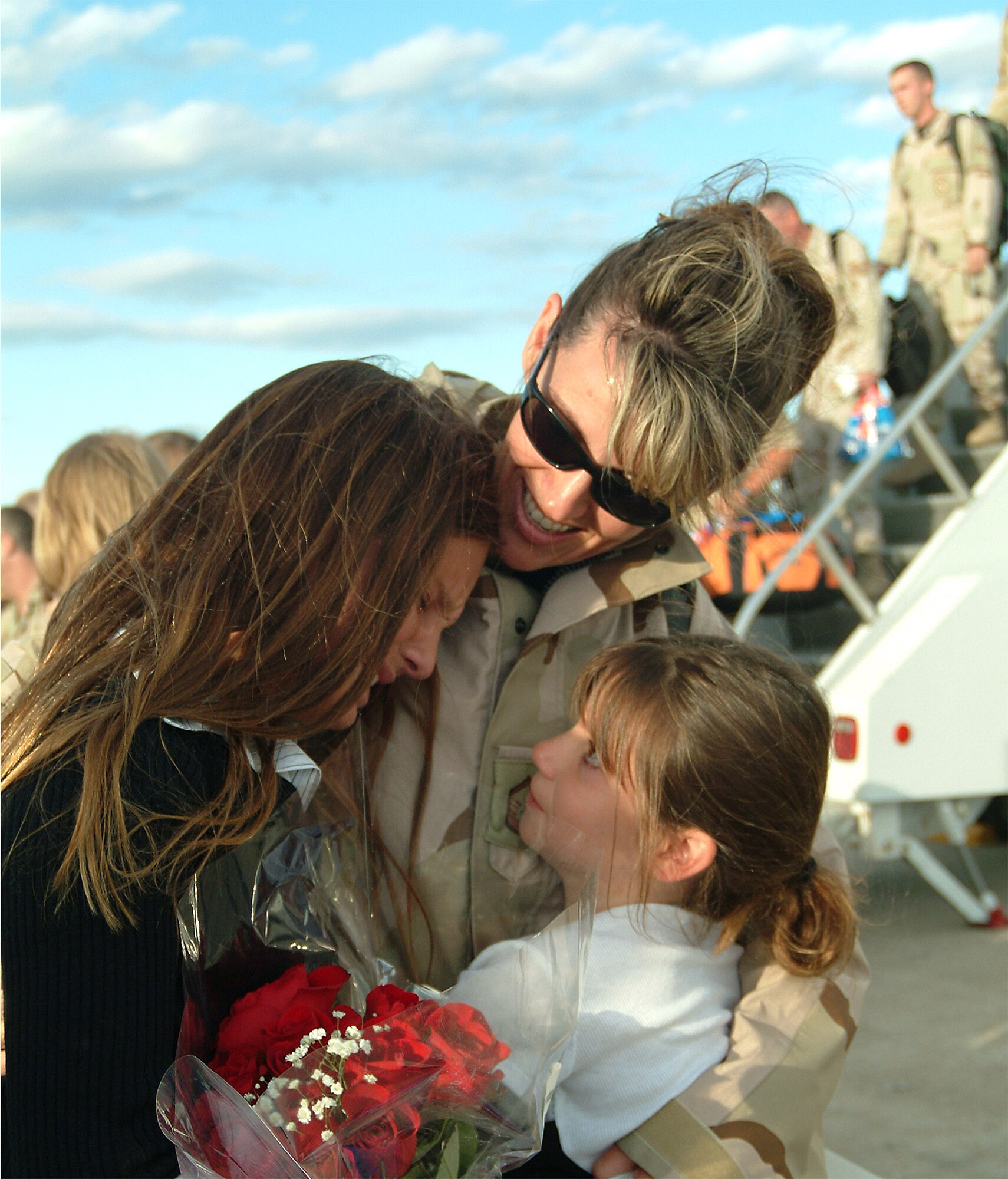 WHITEMAN AFB, Mo. -- Master Sgt. Tammy Eddings, a reservist with the 442nd Fighter Wing's 442nd Mission Support Flight here, embraces her children after returning Sept. 18, from an Operation Enduring Freedom deployment.The 442nd Fighter Wing had been deployed in support of OEF since May. (US Air Force photo / Master Sgt. Bill Huntington)