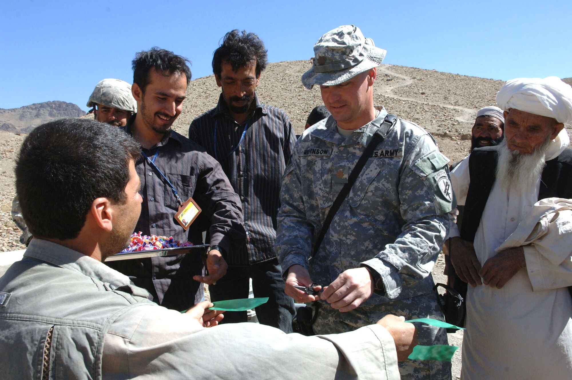 Army Major Don Johnson, team leader of the Air Force-led Bagram Provincial Reconstruction Team, oversees the opening of a new well in the Kohi Safi valley in the Parwan Province of Afghanistan.  The well will provide clean drinking water to several hundred villagers in the nearby village of Baba ghombakay. (U.S. Air Force photo/Tech. Sgt. Joseph Kapinos)