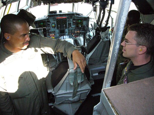 Botswana Defence Force Capt. Tino Phuthego, C-130 pilot, and U.S. Air Force Maj. Jim Wandmacher, 86th Operations Support Squadron C-130 navigator, discuss preflight procedures Sept. 24 at the Kigali International Airport in Rwanda. Photo by Capt. Erin Dorrance