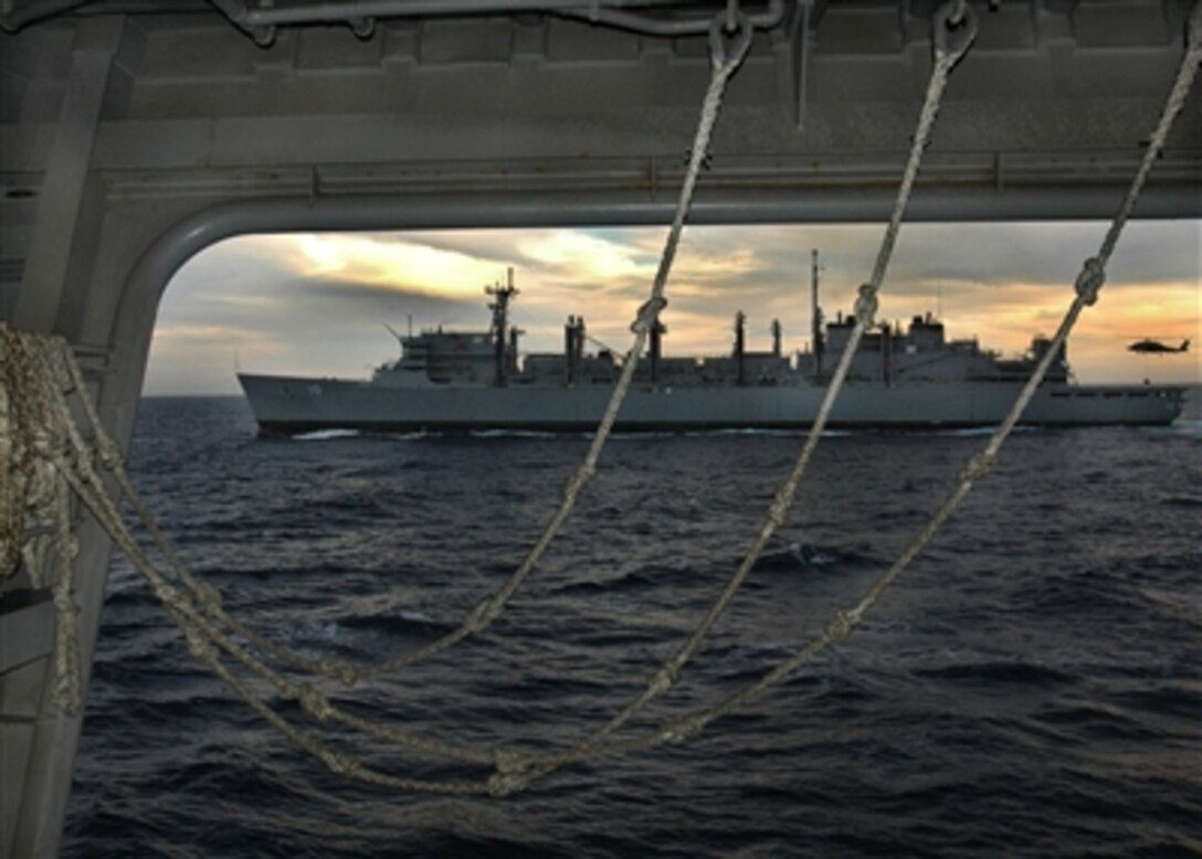 An HH-60H Seahawk helicopter delivers supplies to the USNS Bridge (T-AOE 10) during a replenishment at sea operation on Oct. 1, 2006.  