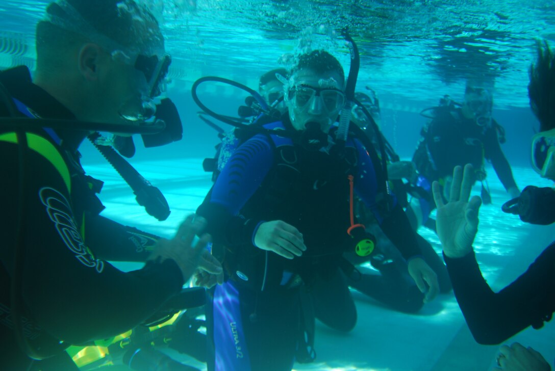 MARINE CORPS BASE CAMP LEJEUNE, N.C. - Lucin Broekhuizen, a diving instructor with AA Diving here on Lejeune, flashes Lance Cpl. Chris Boreland the O.K. sign while they practice scuba drills at Area 2 pool with his fellow Marines from the Wounded Warrior Barracks Oct. 3. (Official U.S. Marine Corps photo by Lance Cpl. Brandon R. Holgersen)(released)