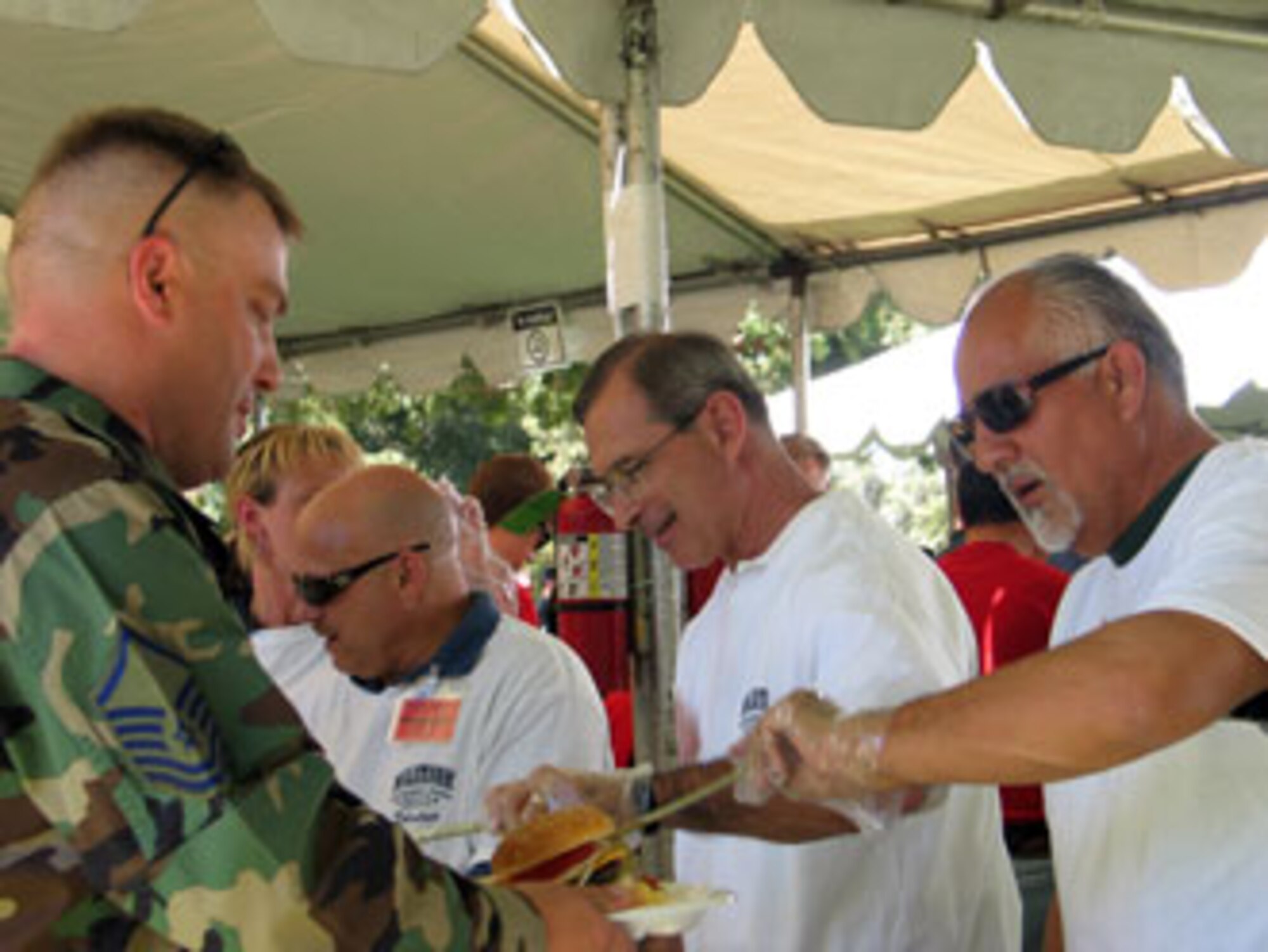 Volunteers serve food during the annual base wide picnic held on Saturday, September 16. The local communities of Riverside and Moreno Valley organized and funded the picnic to show their appreciation to the military members who work at the base. More than 5,000 military members and their families attended the event. This is the 34th appreciate day picnic the community has hosted for March Air Reserve Base. (U.S. Air Force photo by MSgt Carson Hampton)