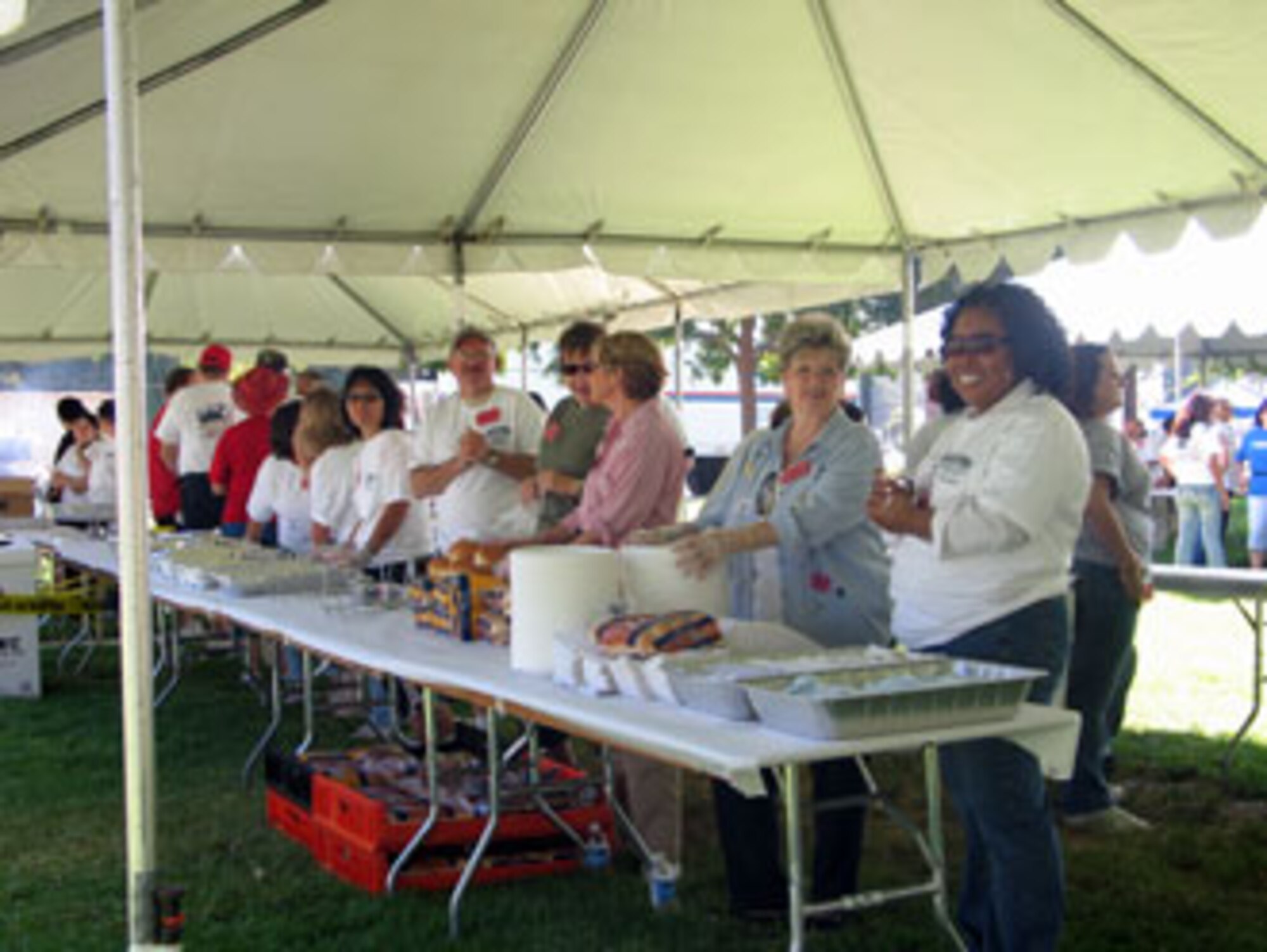 Volunteers serve food during the annual base wide picnic held on Saturday, September 16. The local communities of Riverside and Moreno Valley organized and funded the picnic to show their appreciation to the military members who work at the base. More than 5,000 military members and their families attended the event. This is the 34th appreciate day picnic the community has hosted for March Air Reserve Base. (U.S. Air Force photo by MSgt Carson Hampton)