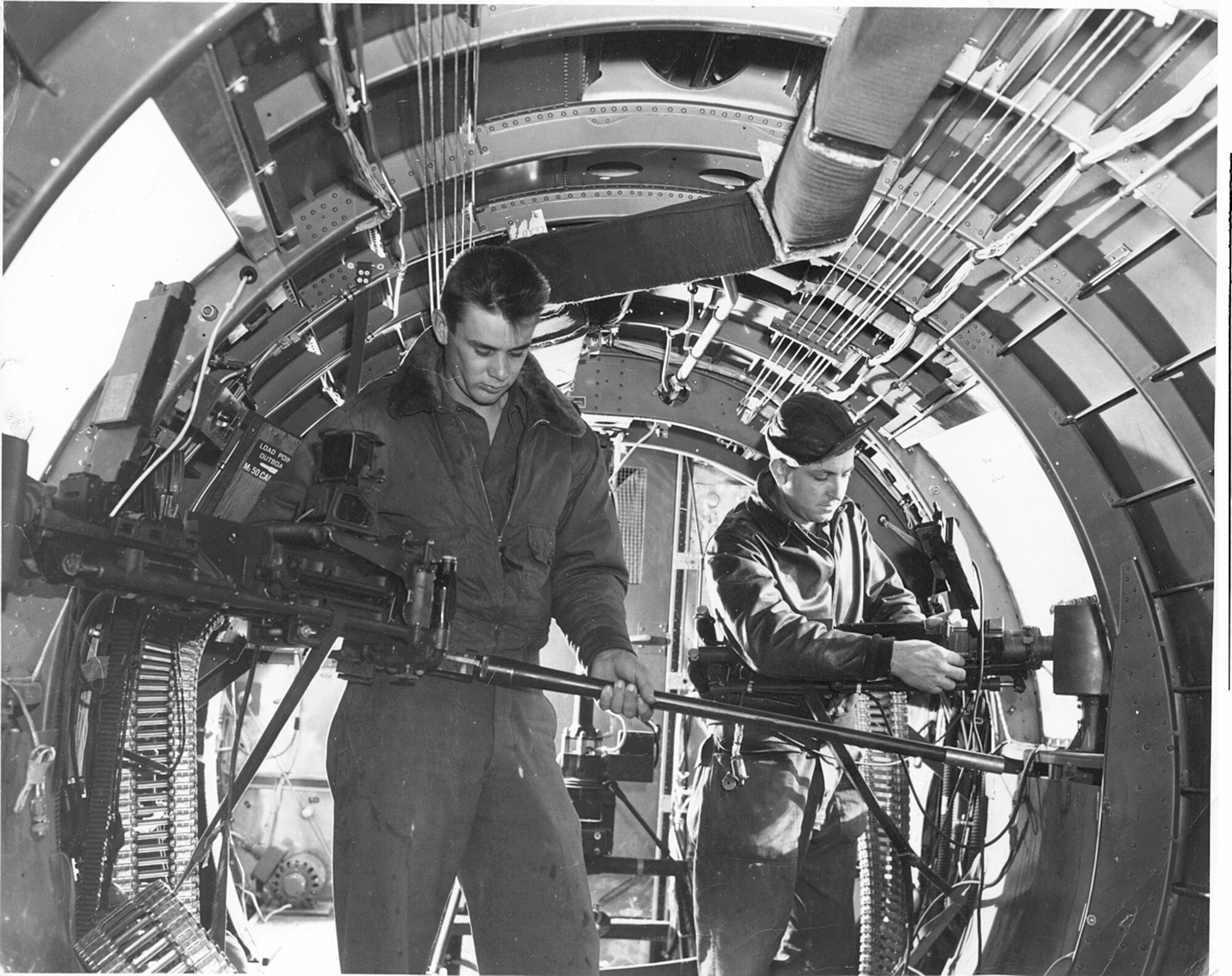 99th Bombardment Group waist gunners ready their machine guns