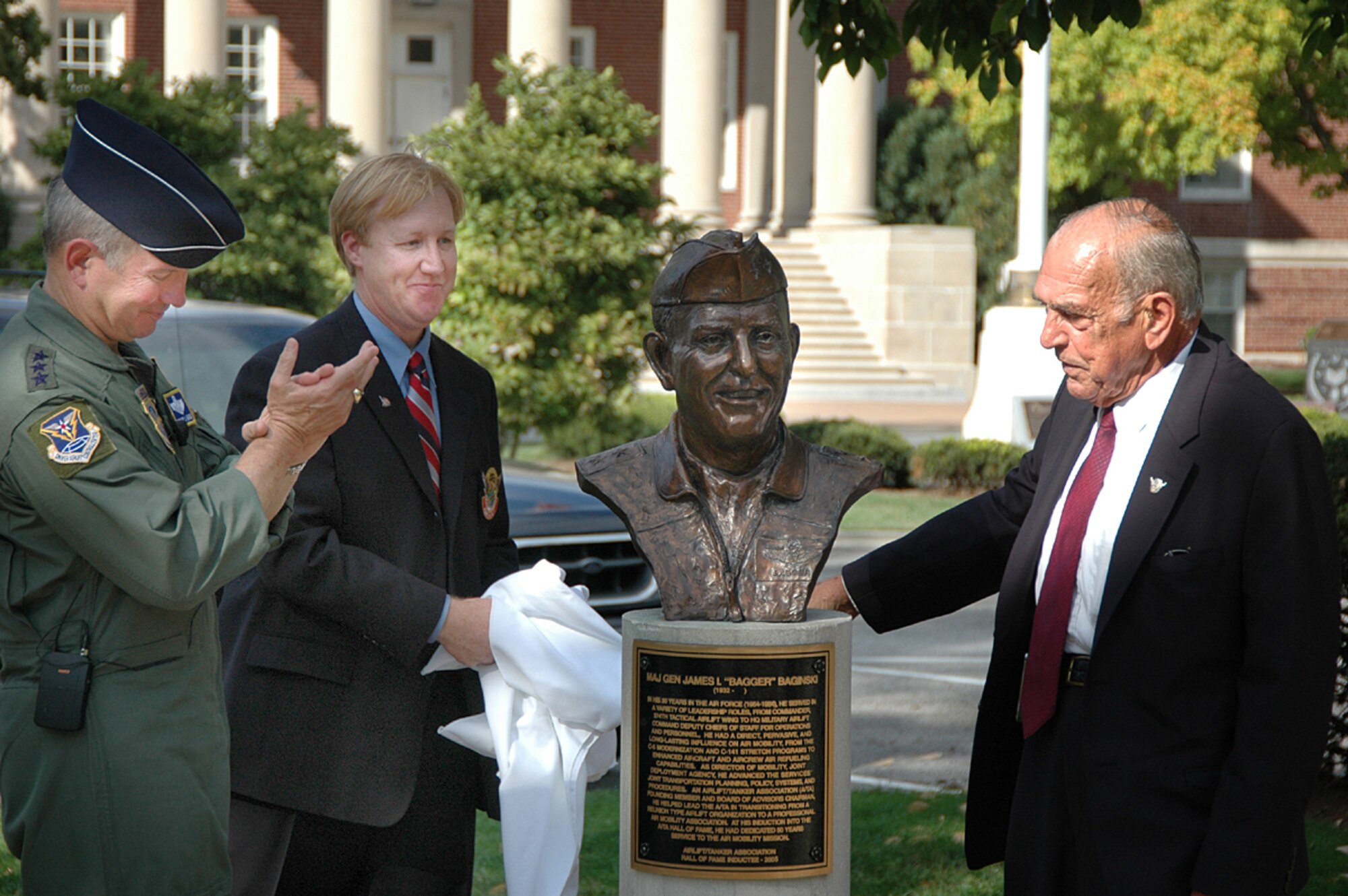 Gen. Duncan McNabb, Air Mobility Command commander; retired Chief Master Sgt. Mark Smith, Airlift/Tanker Association president; and retired Maj. Gen. James "Bagger" Baginski unveil his bust at the A/TA Hall of Fame Memorial, Oct. 2.