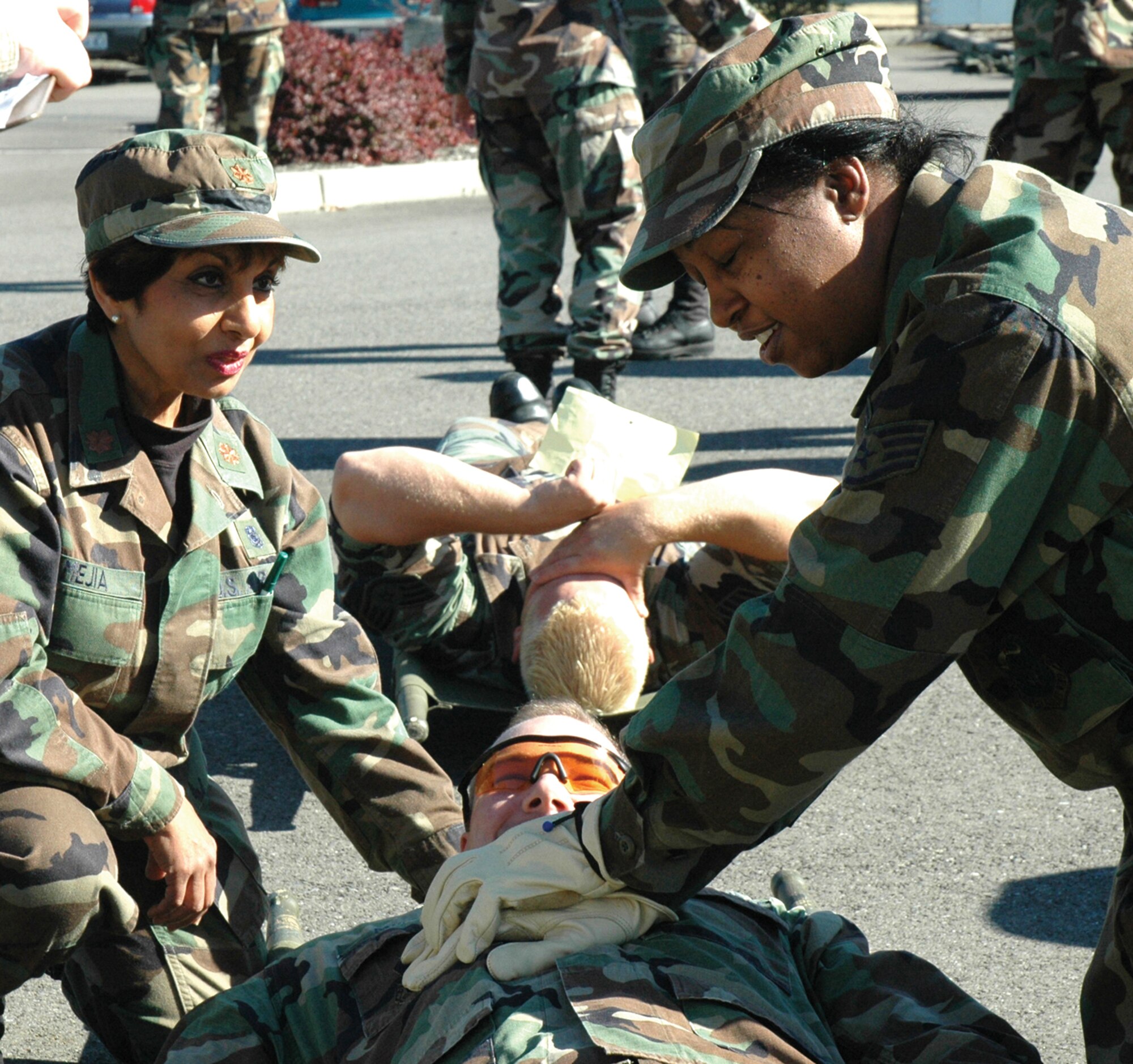 McCHORD AIR FORCE BASE, Wash., - Maj. Joyce Mejia, (left) a clinical nurse, and Staff Sgt. Debra Levine, a medical technician, perform mock CPR on Master Sgt. Charles Miller, a paramedic, during a 446th Aeromedical Staging Squadron mass casualty exercise Sept. 24. More than 100 ASTS Reservists participated in the annual exercise.  (USAF photo by Capt. Jennifer Gerhardt)