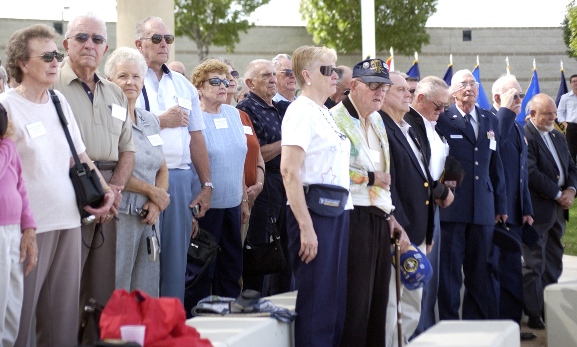 Some of the 150 attendees at the Berlin Airlift plaque dedication stand for the national anthem during Berlin Airlift plaque dedication at Veterans Memorial Park Oct. 4. (U.S. Air Force Photo/Staff Sgt. Jeremy Larlee)