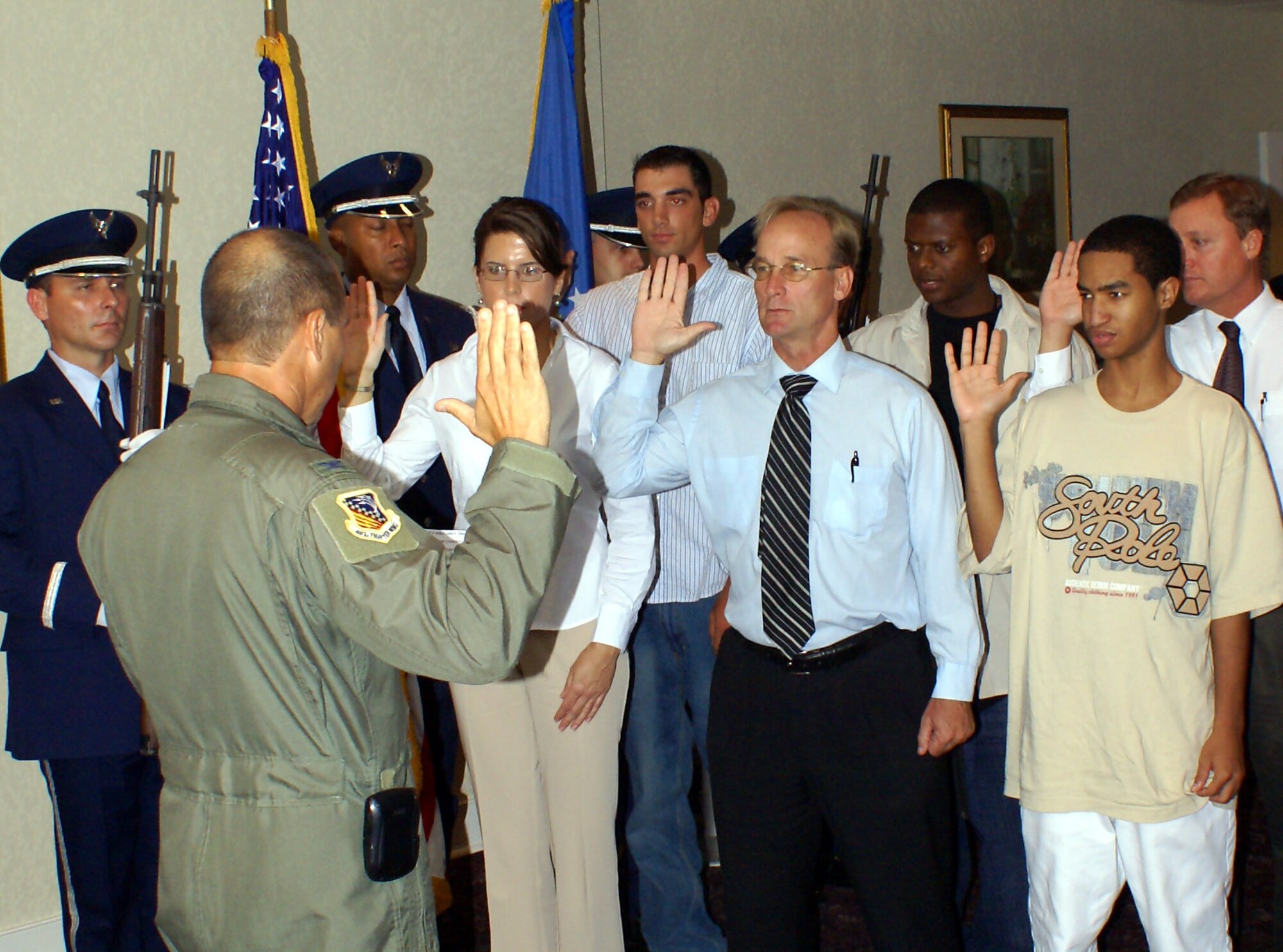 482nd Fighter Wing Commander Col Randy Falcon swears in six new Air Force Reservists at Homestead Air Reserve Base, Fla., during a mass enlistment ceremony Oct. 5.  Enlistees pictured left to right are:  Jennifer Kidson, Chris Frank, Charles Moye, Robert Gibson-Pierre, Adriel Brandon and Michael Keane.  All of them will be joining the 482nd Fighter Wing as members of the Air Force Reserve in the near future (Air Force photo by Jake Shaw).
