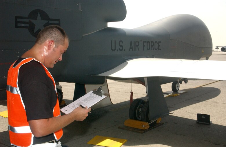Staff Sgt. Michael Delaune reviews a post-flight checklist for the Global Hawk unmanned aerial vehicle following a mission Oct. 3 at a deployed location in Southwest Asia. The Global Hawk flies missions in support of operations Iraqi Freedom and Enduring Freedom from this deployed location. Sergeant Delaune is assigned to the 380th Expeditionary Maintenance Group. (U.S. Air Force photo/Master Sgt. Jason Tudor) 
