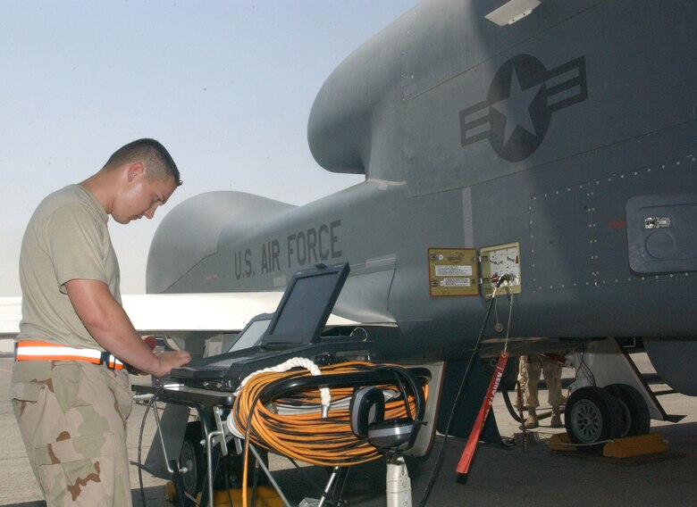 Senior Airman Gordon Casselman checks the digital maintenance logs on a Global Hawk unmanned aerial vehicle following a mission Oct. 3 at a deployed location in Southwest Asia. The Global Hawk can survey large geographic areas with pinpoint accuracy to give military decision-makers the most current information about enemy locations, resources and members. Airman Casselman is assigned to the 380th Expeditionary Maintenance Group. (U.S. Air Force photo/Master Sgt. Jason Tudor)
