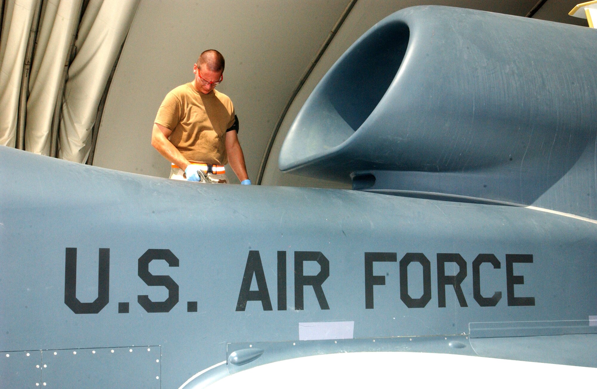 Staff Sgt. Michael Wilmoth refuels a Global Hawk unmanned aerial vehicle following a mission Oct. 3 at a deployed location in Southwest Asia. The Global Hawk can survey large geographic areas with pinpoint accuracy to give military decision-makers the most current information about enemy locations, resources and members. Sergeant Wilmoth is assigned to the 380th Expeditionary Maintenance Group. (U.S. Air Force photo/Master Sgt. Jason Tudor)