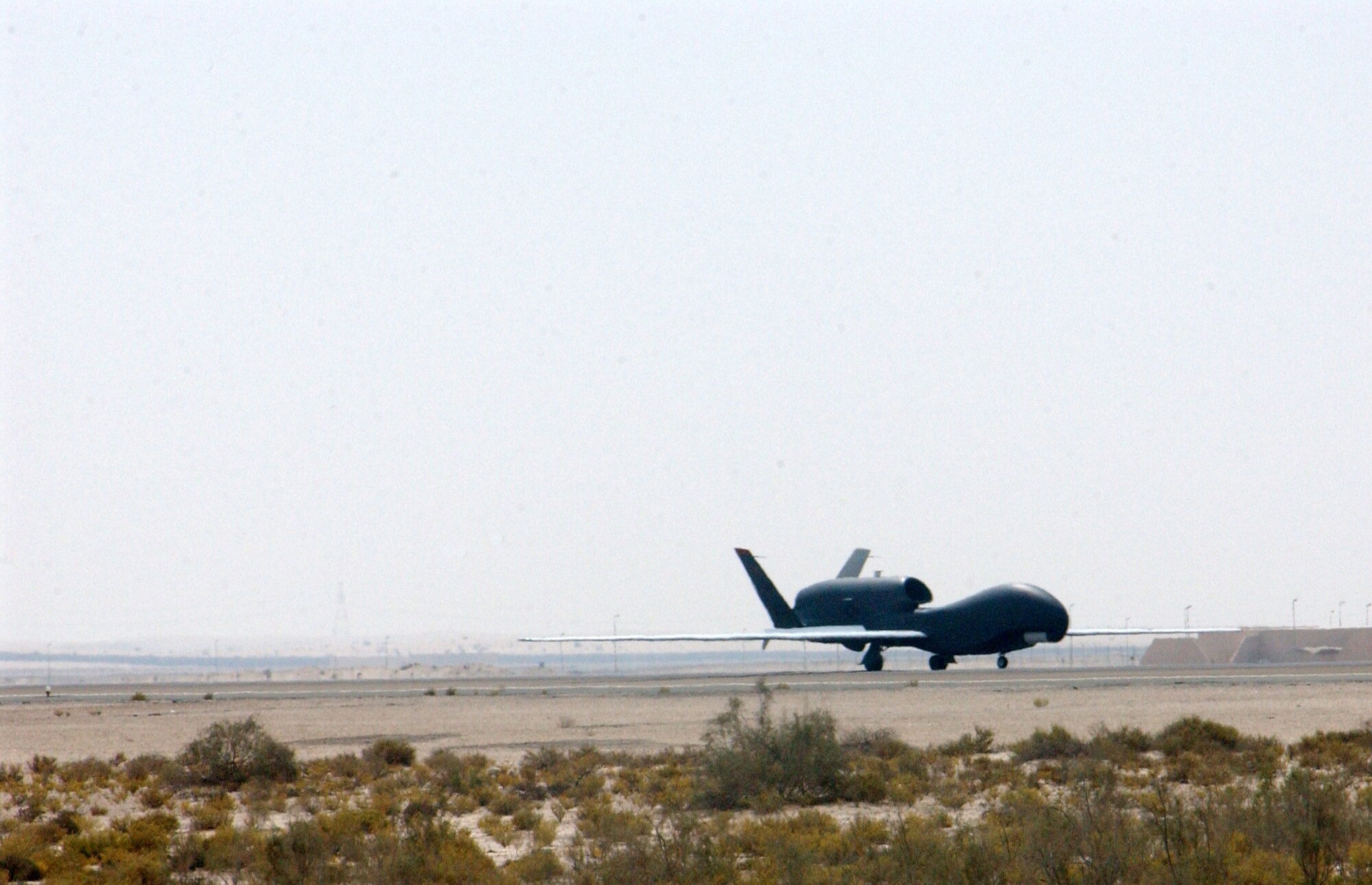 A Global Hawk unmanned aerial vehicle lands at a deployed location in Southwest Asia following a mission Oct. 3. The Global Hawk provides Air Force and joint battlefield commanders near-real-time, high-resolution, intelligence, surveillance and reconnaissance imagery. The Global Hawk is currently supporting operations Iraqi Freedom and Enduring Freedom from this deployed location. (U.S. Air Force photo/Master Sgt. Jason Tudor)